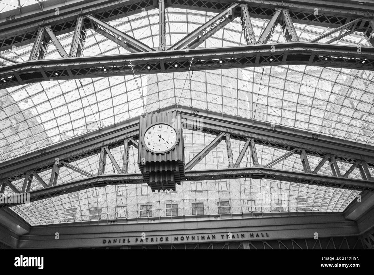 Clock and the sky-lit roof of the Moynihan Train Hall in Manhattan, New York City, New York, USA, named after the late US Sen. Daniel Patrick Moynihan. Stock Photo