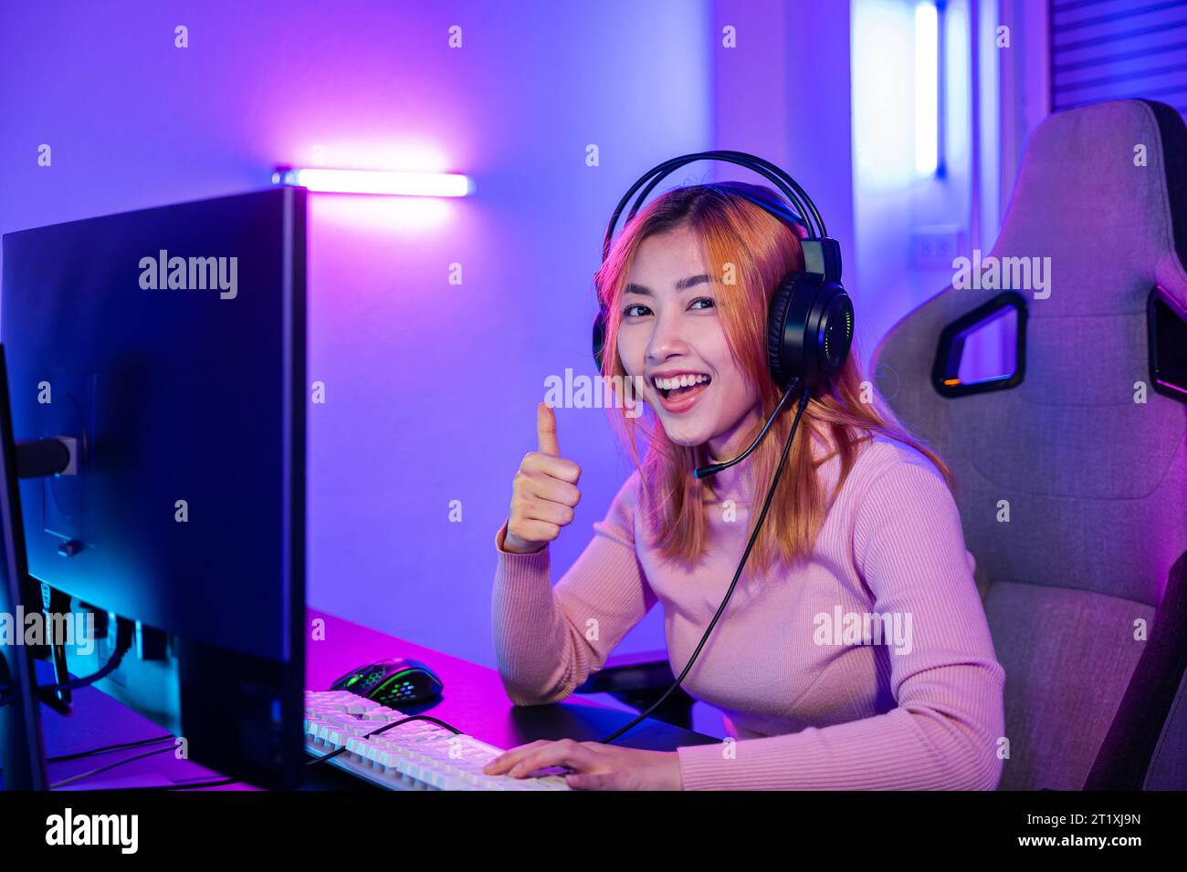 Gamer playing online game wear gaming headphones looking to camera ...