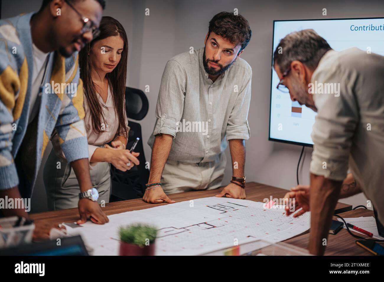 Multicultural professionals collaborate in a conference room ...