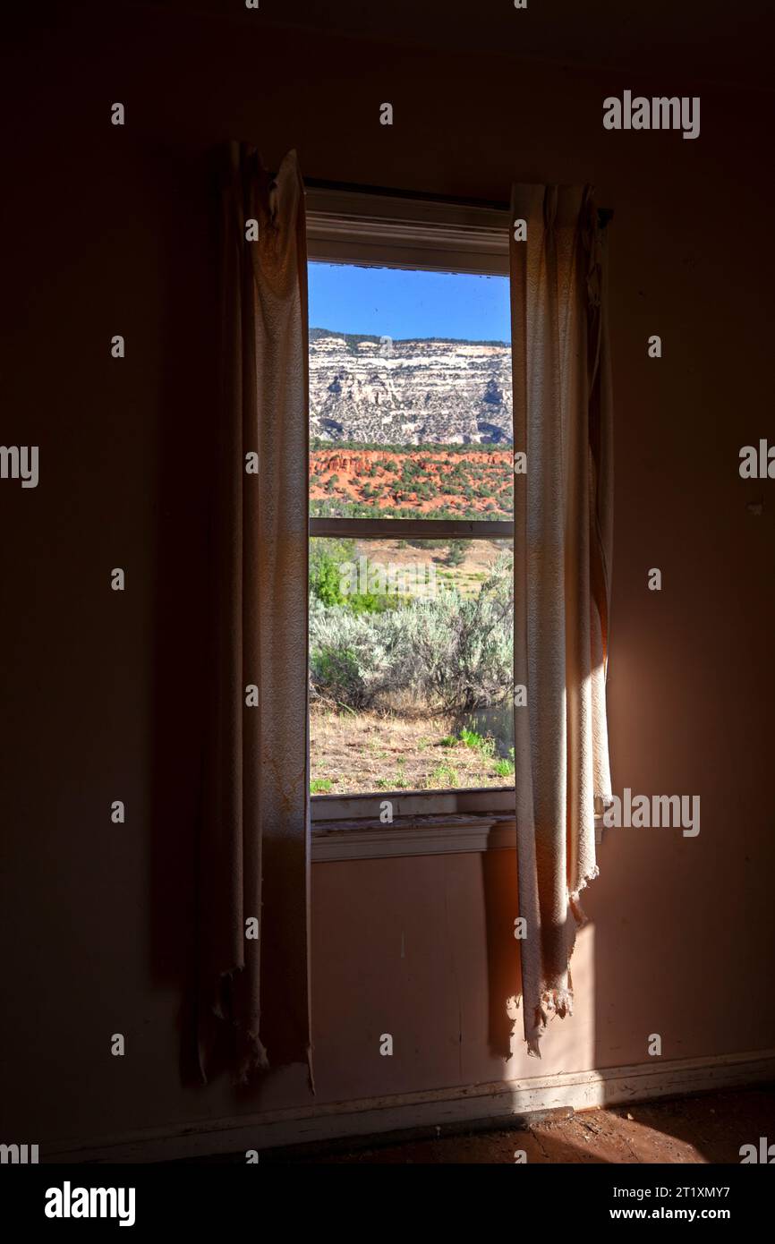 Frayed curtains still hang beside a bedroom window in the Rial Chew ...