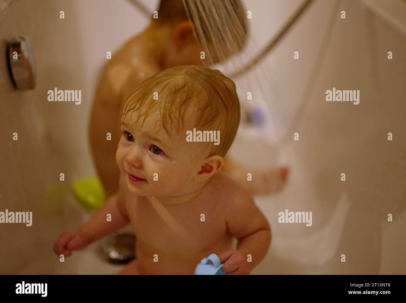 Cute little children having shower in bathtub Stock Photo