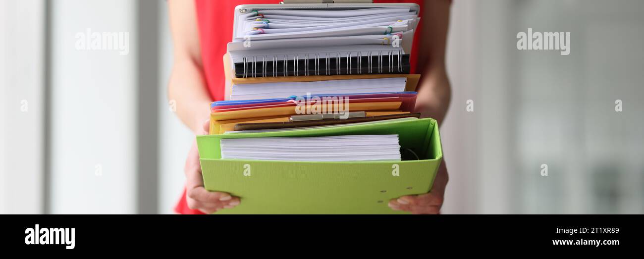 Secretary in red blouse holds stack of folders in hands Stock Photo - Alamy