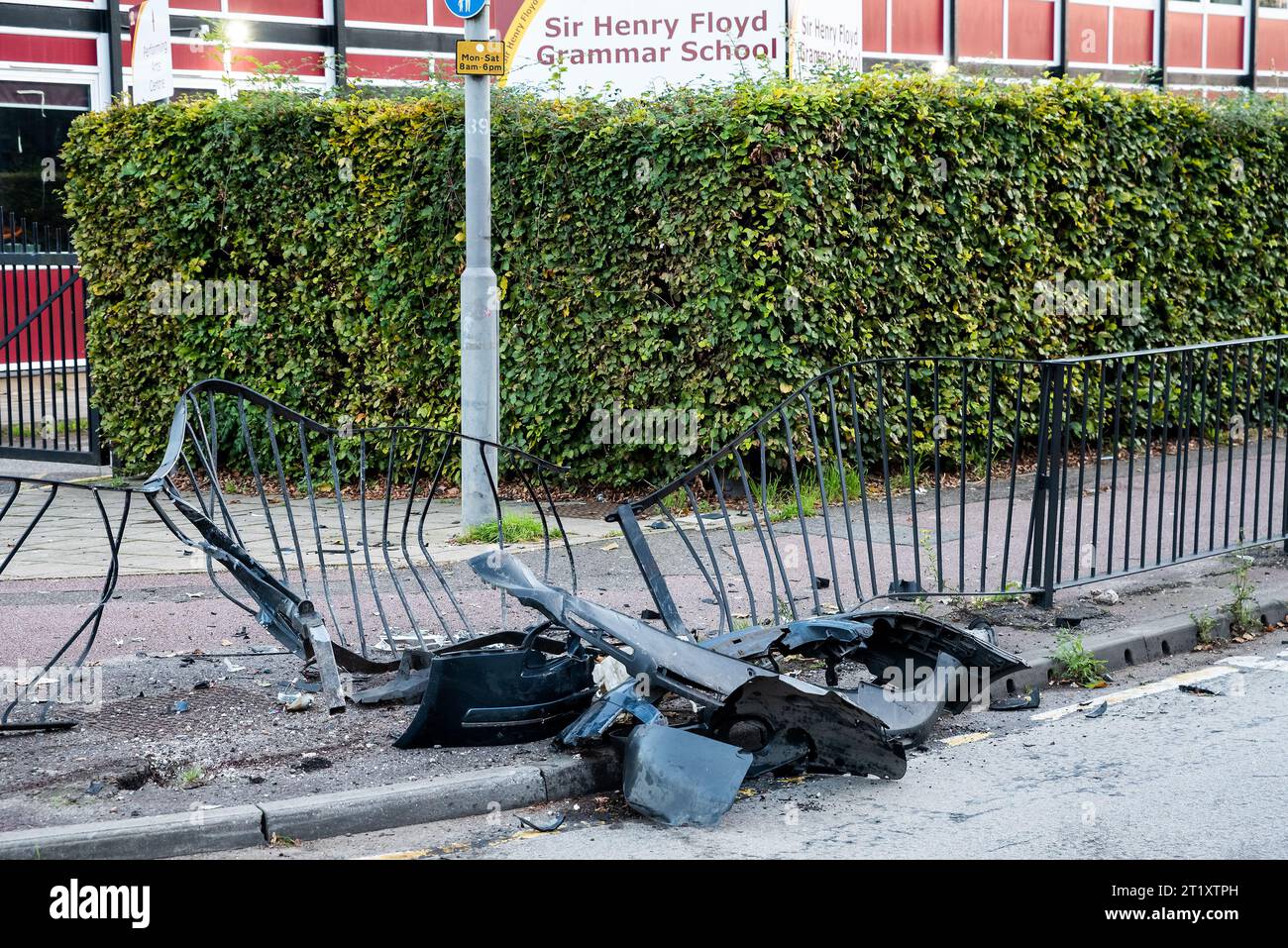 Serious vehicle impact damage to roadside pavement pedestrian barrier outside Aylesbury Sir Henry Floyd Grammar School. Credit: Stephen Bell/Alamy Stock Photo