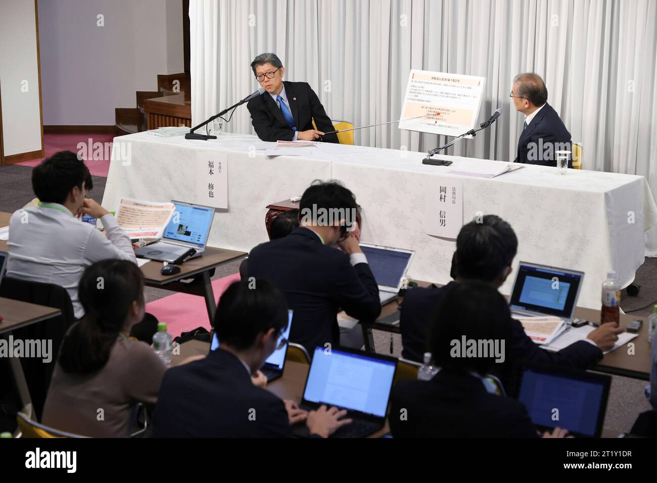 Nobuo Okamura (R) procurator general of the Family Federation for
