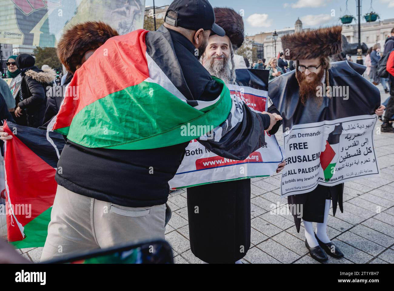 Jewish and Arabic people shake hands and respectfully chat at the Pro Palestinian march in London. Stock Photo