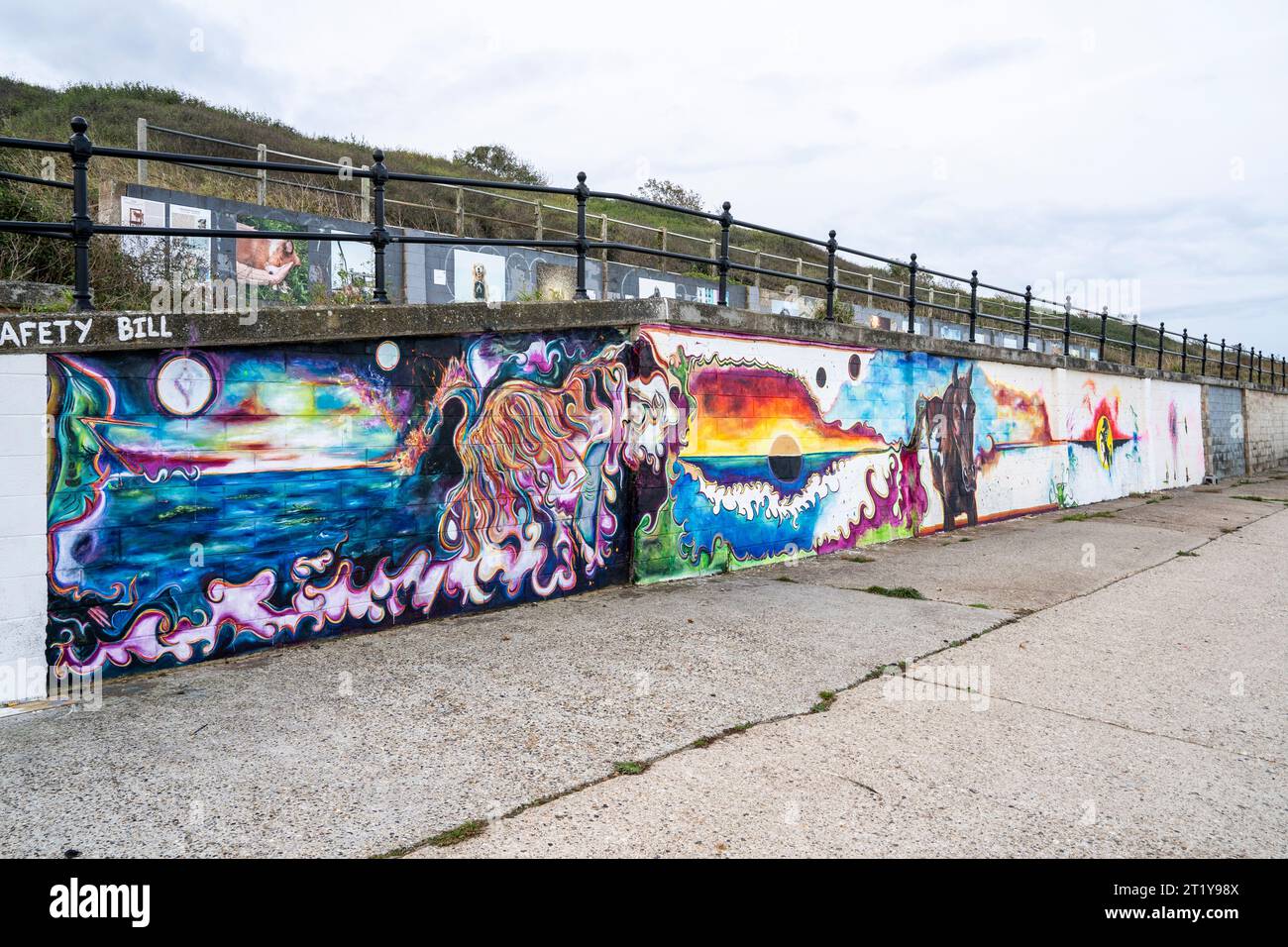 Series of connected wall paintings on a seawall at Herne Bay in Kent. Painted by an unknown your woman artist, the pictures, apart from one are connected by a horizon, and feature a dragon and a black stallion. Stock Photo