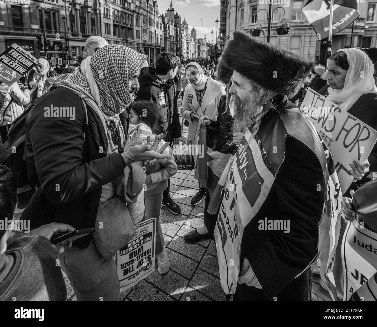Black and white image of Jewish and Arabic people conversing respectfully at Pro Palestinian march in London. Stock Photo