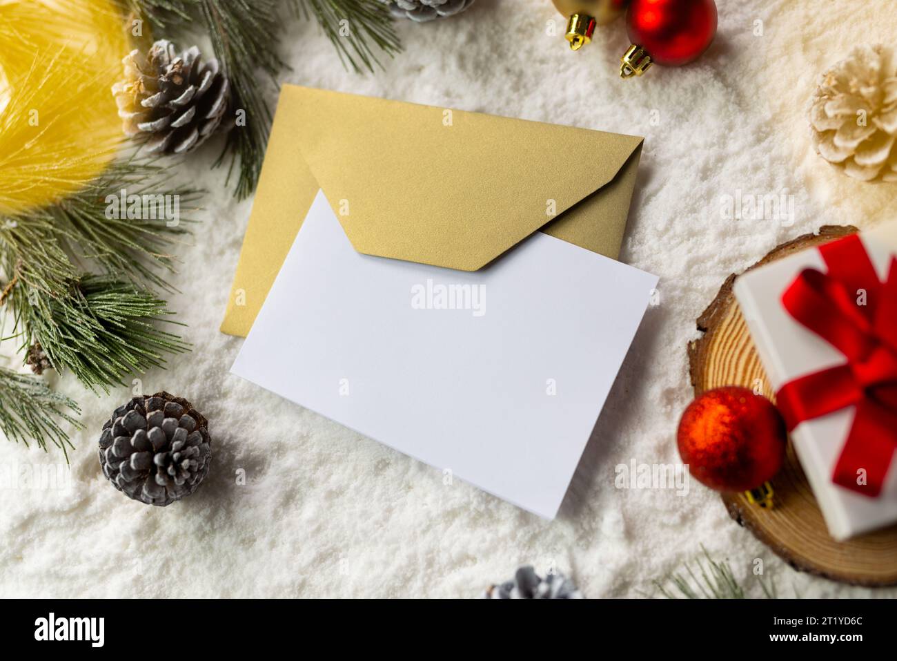 Christmas decorations and white card with copy space on snow background ...