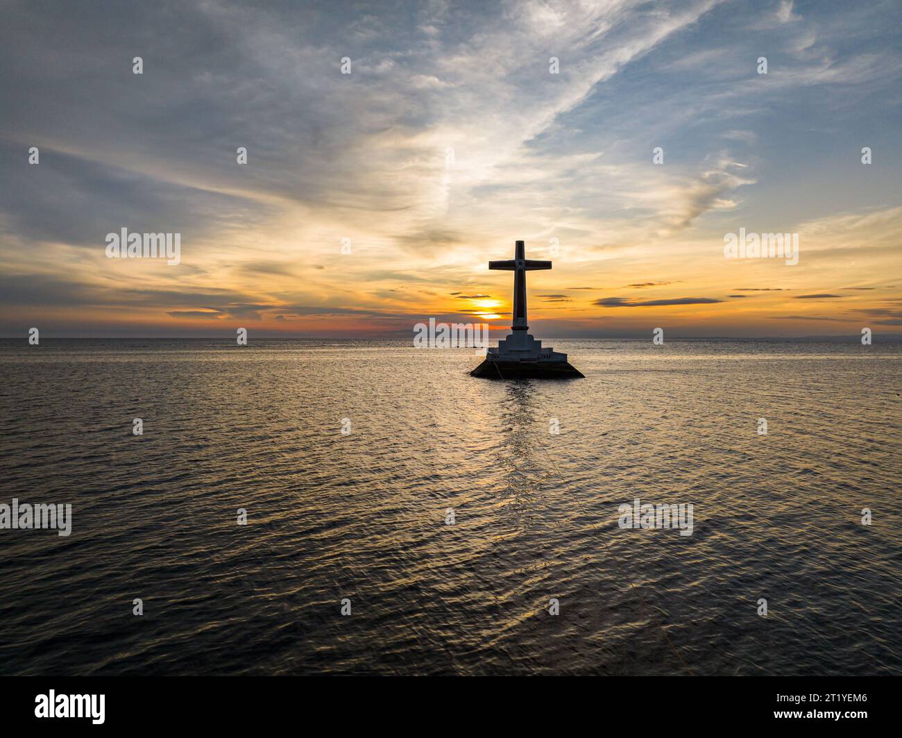 Sunset background on large cross of Sunken Cemetery in Camiguin Island. Philippines. Stock Photo