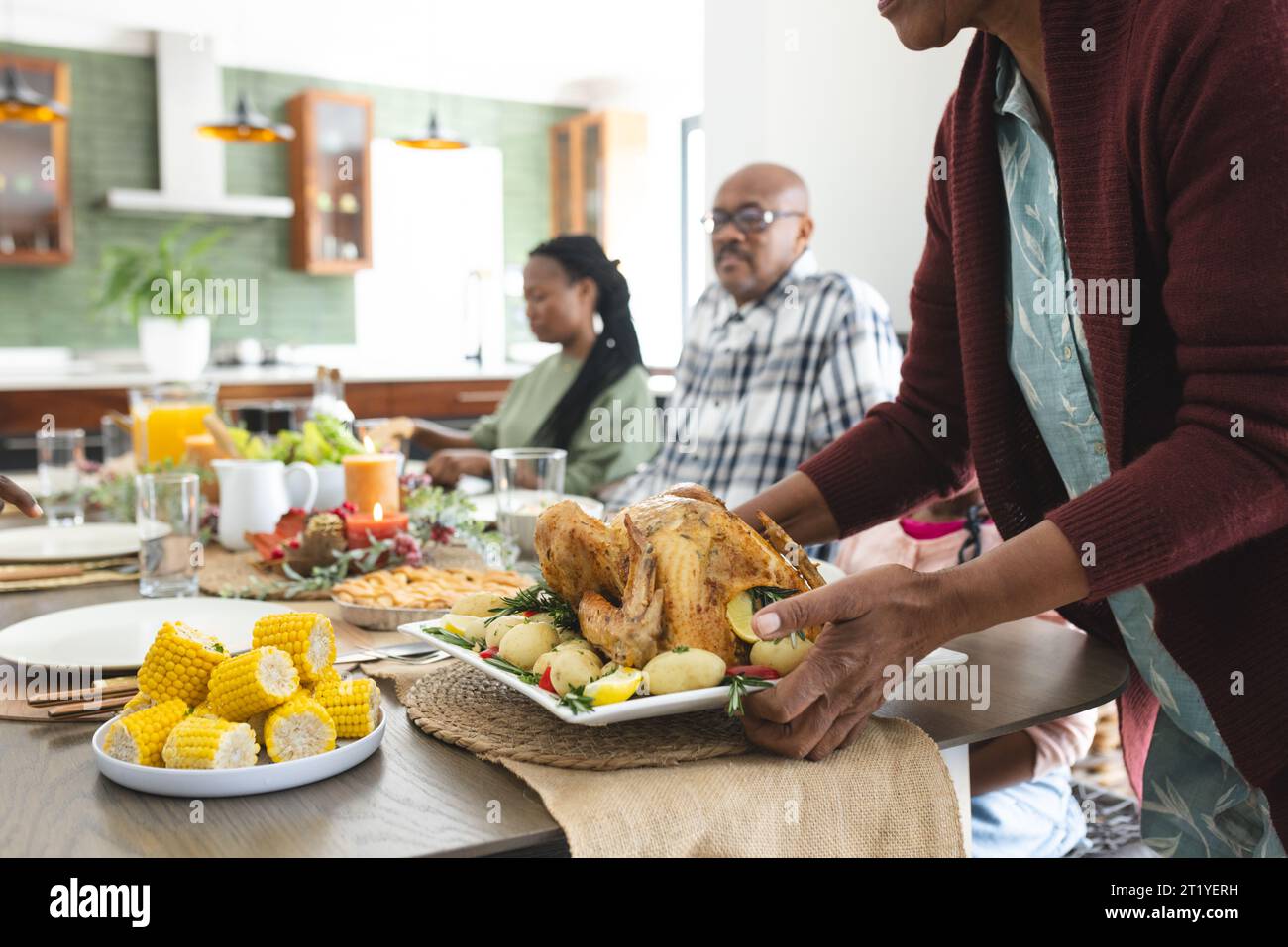 Happy african american multi generation family serving food at