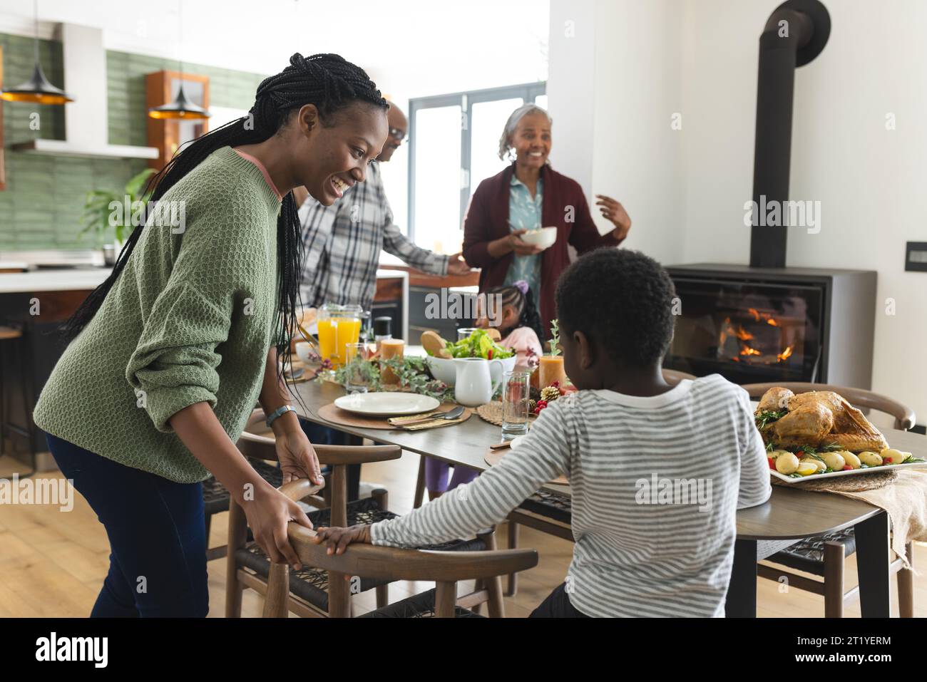 Happy african american multi generation family serving food at