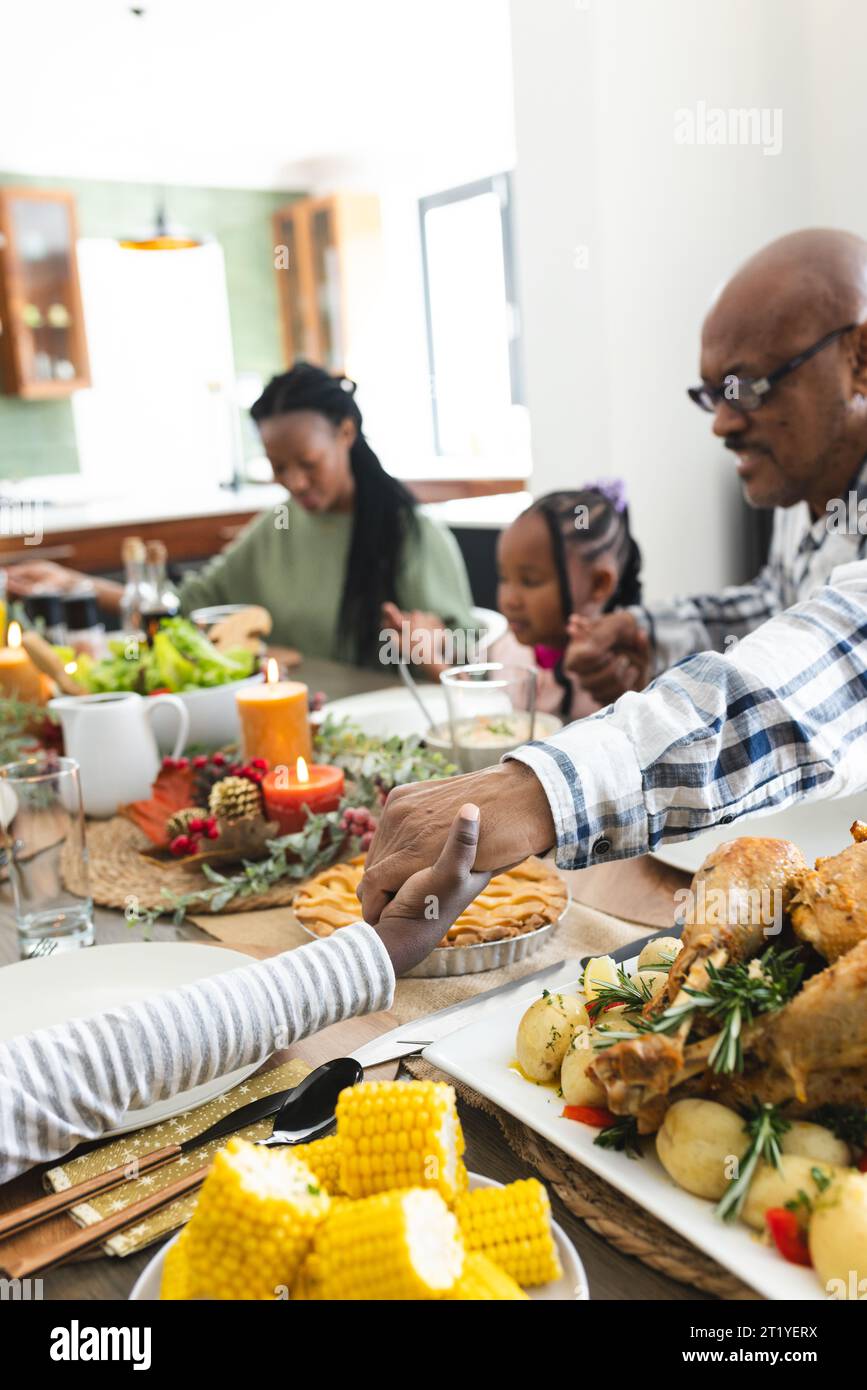 Happy african american multi generation family holding hands at