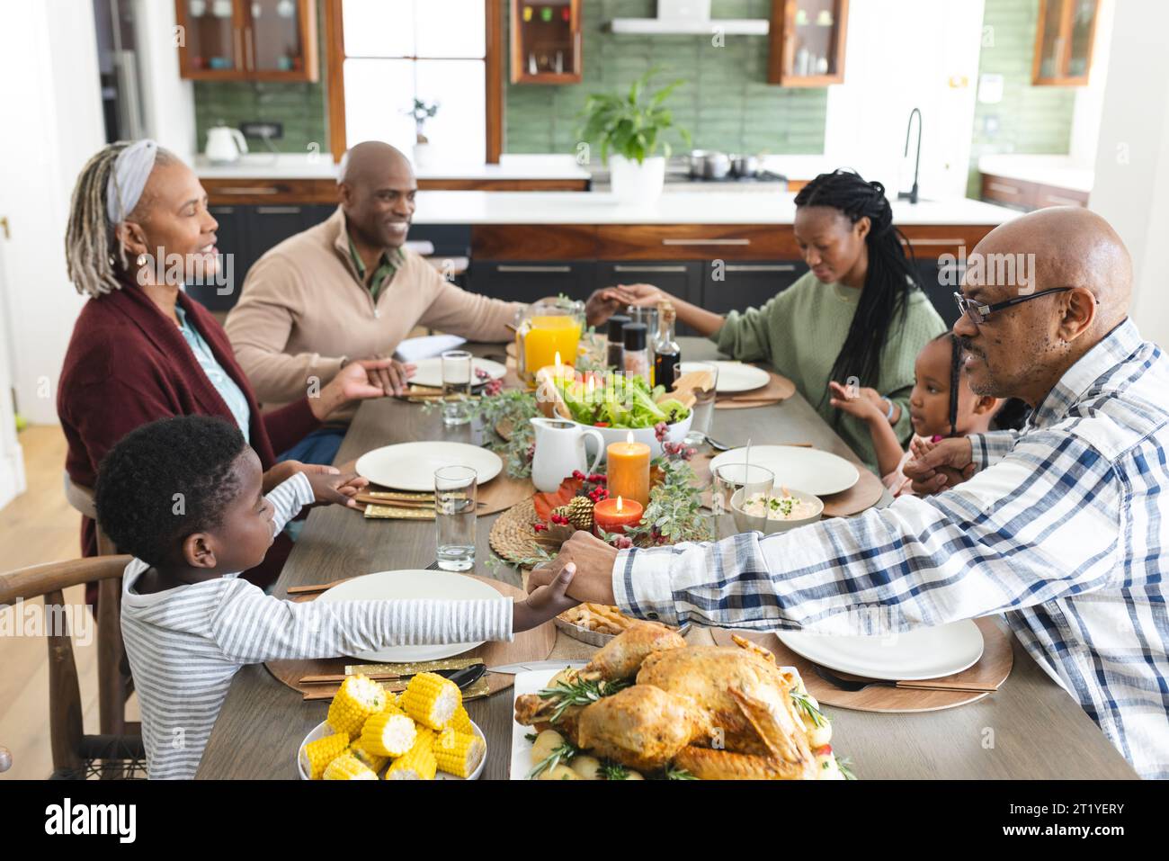 Happy african american multi generation family holding hands at