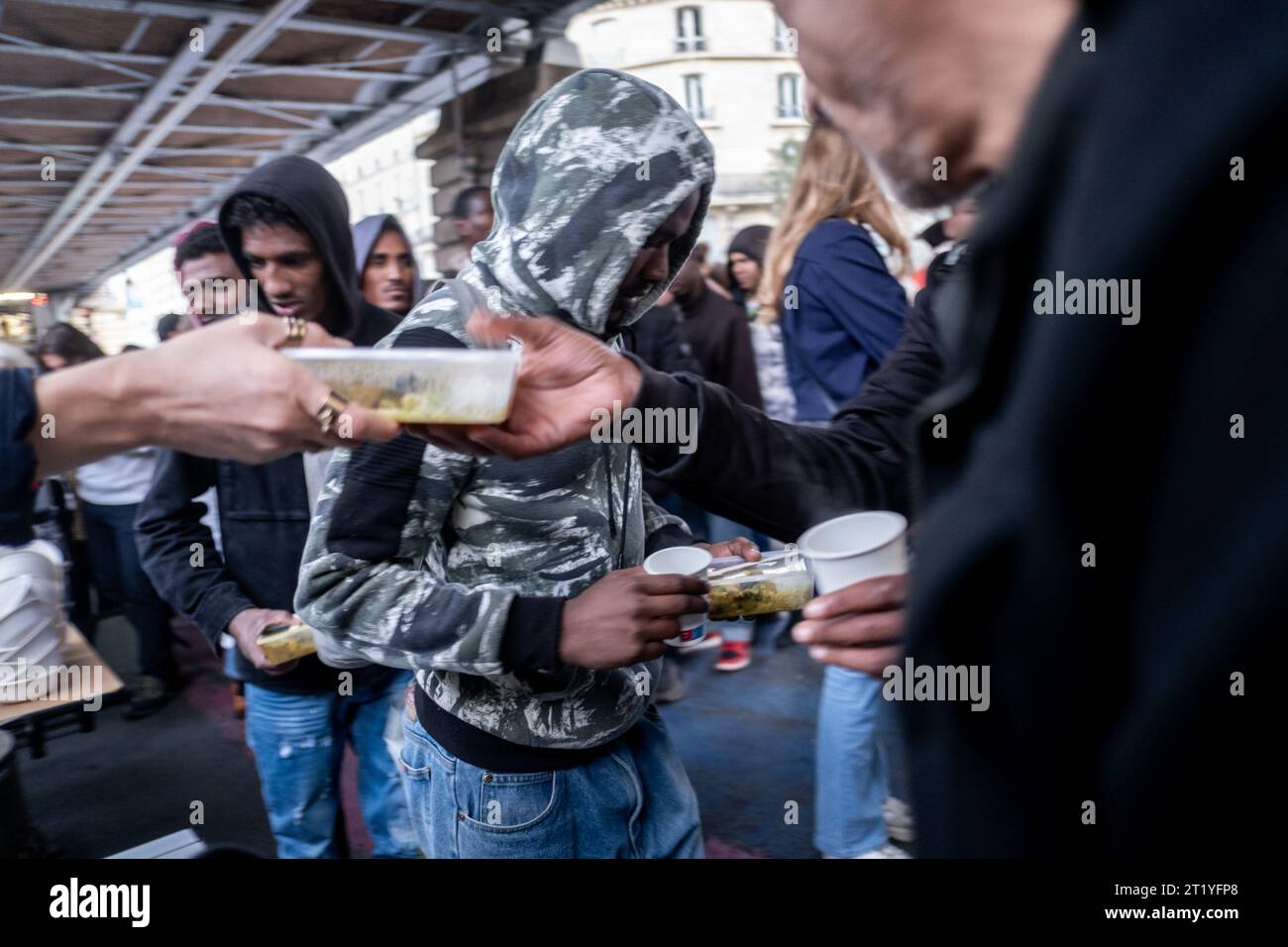 Paris, France. 15th Oct, 2023. Michael Bunel/Le Pictorium - Food distribution under the La Chapelle metro station - 15/10/2023 - France/France/Paris - Food distribution under the La Chapelle metro station organized by various associations and NGOs (Utopia 56, MDM, tendre la main, paris exil, la chorba, solidarite migrant wilson .). For the past week, a prefectoral decree has prohibited food aid for refugees, migrants and exiles in several streets in northern Paris. October 15, 2023. Paris, France. Credit: LE PICTORIUM/Alamy Live News Stock Photo