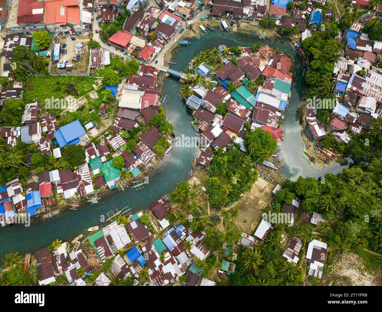 Fishermen Houses and Cold Spring surrounded by tropical forest. Surigao del Sur. Philippines. Stock Photo