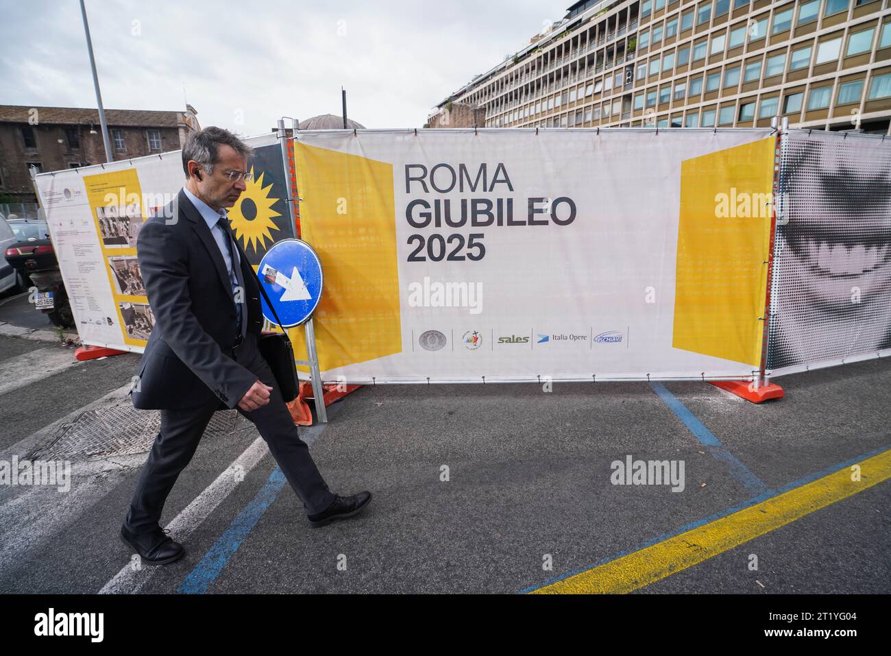 Rome, Italy 16 October 2023. A pedestrian walks past hoarding to mark