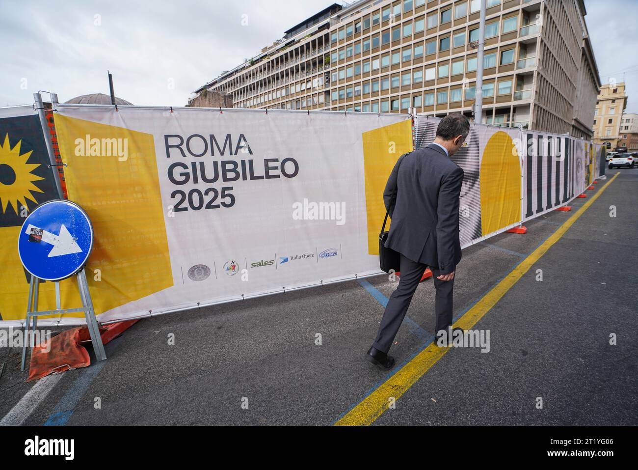 Rome, Italy 16 October 2023. A pedestrian walks past hoarding to mark
