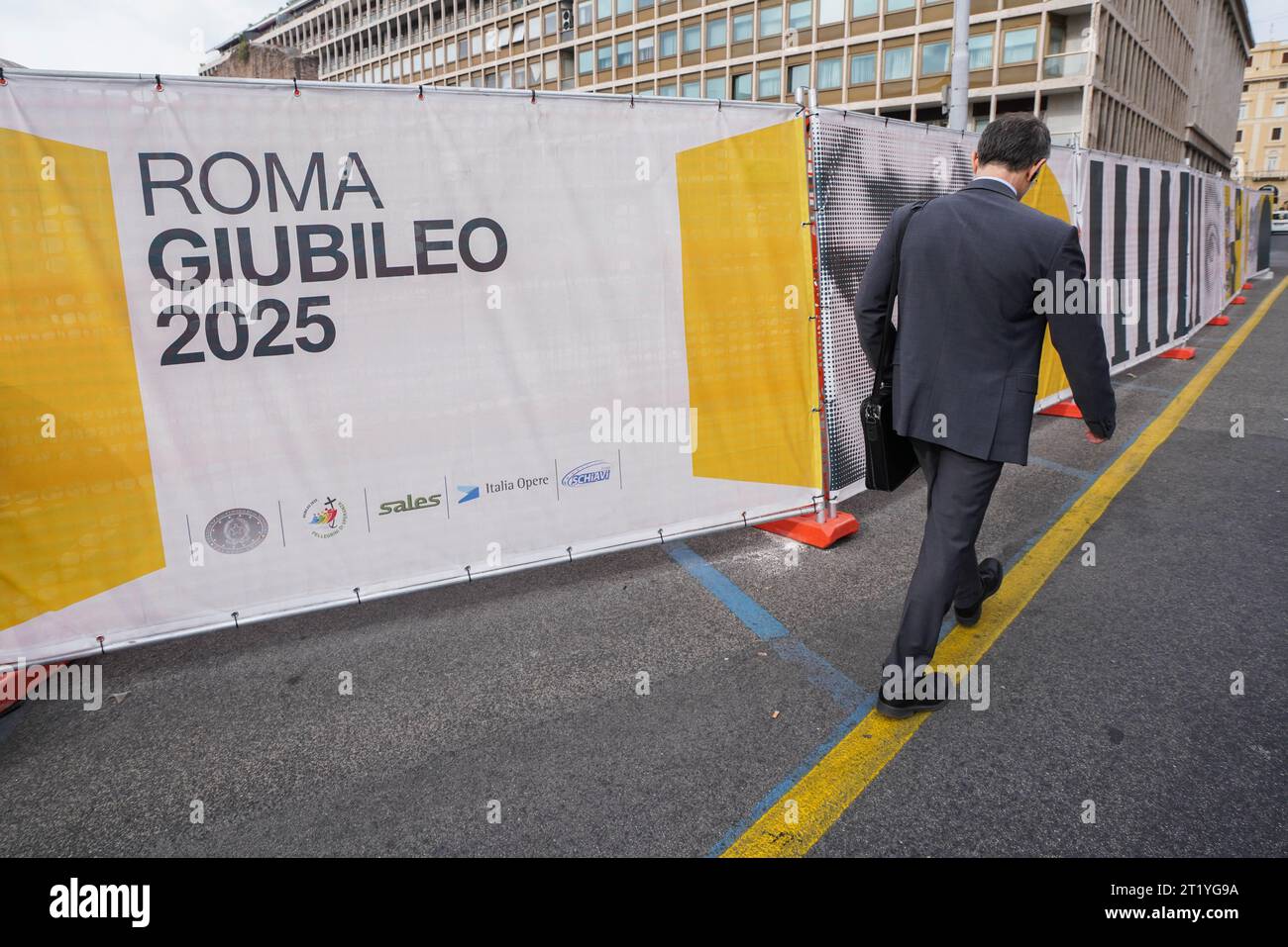 Rome, Italy 16 October 2023. A pedestrian walks past hoarding to mark