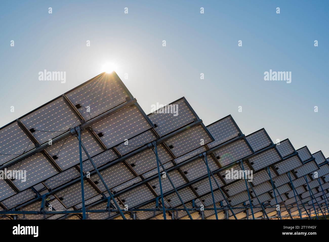 Sun glinting off Solar PV Photovoltaic panels at the Uterne Solar Farm in Central Australia near Alice Springs (Mparntwe) in the Northern Territory Stock Photo