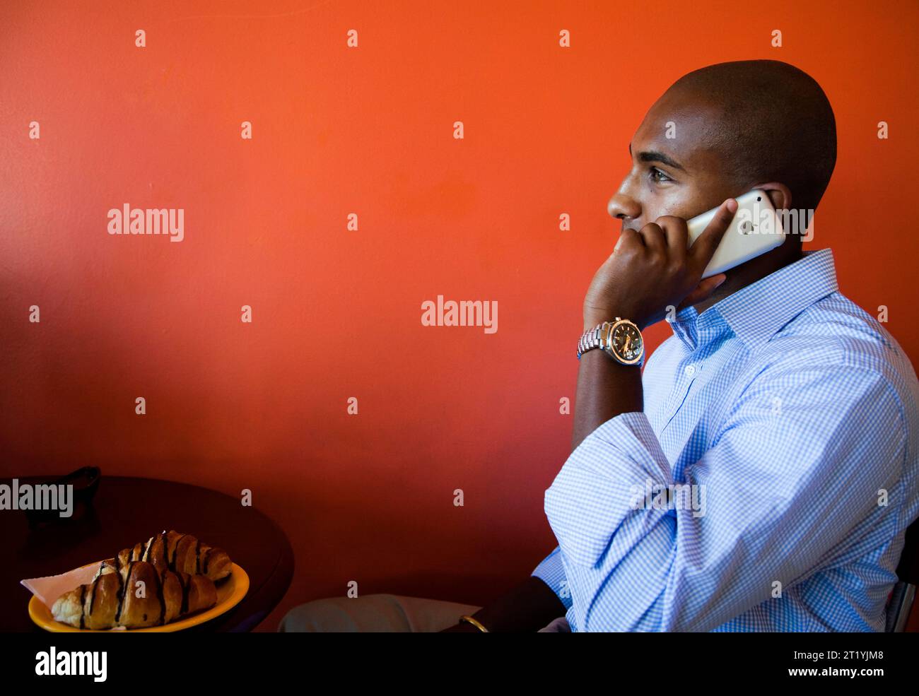 A young Ethiopian business man, talks on his cellular phone while city