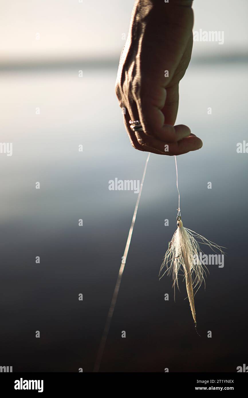 Hand holding fishing line hi-res stock photography and images - Alamy
