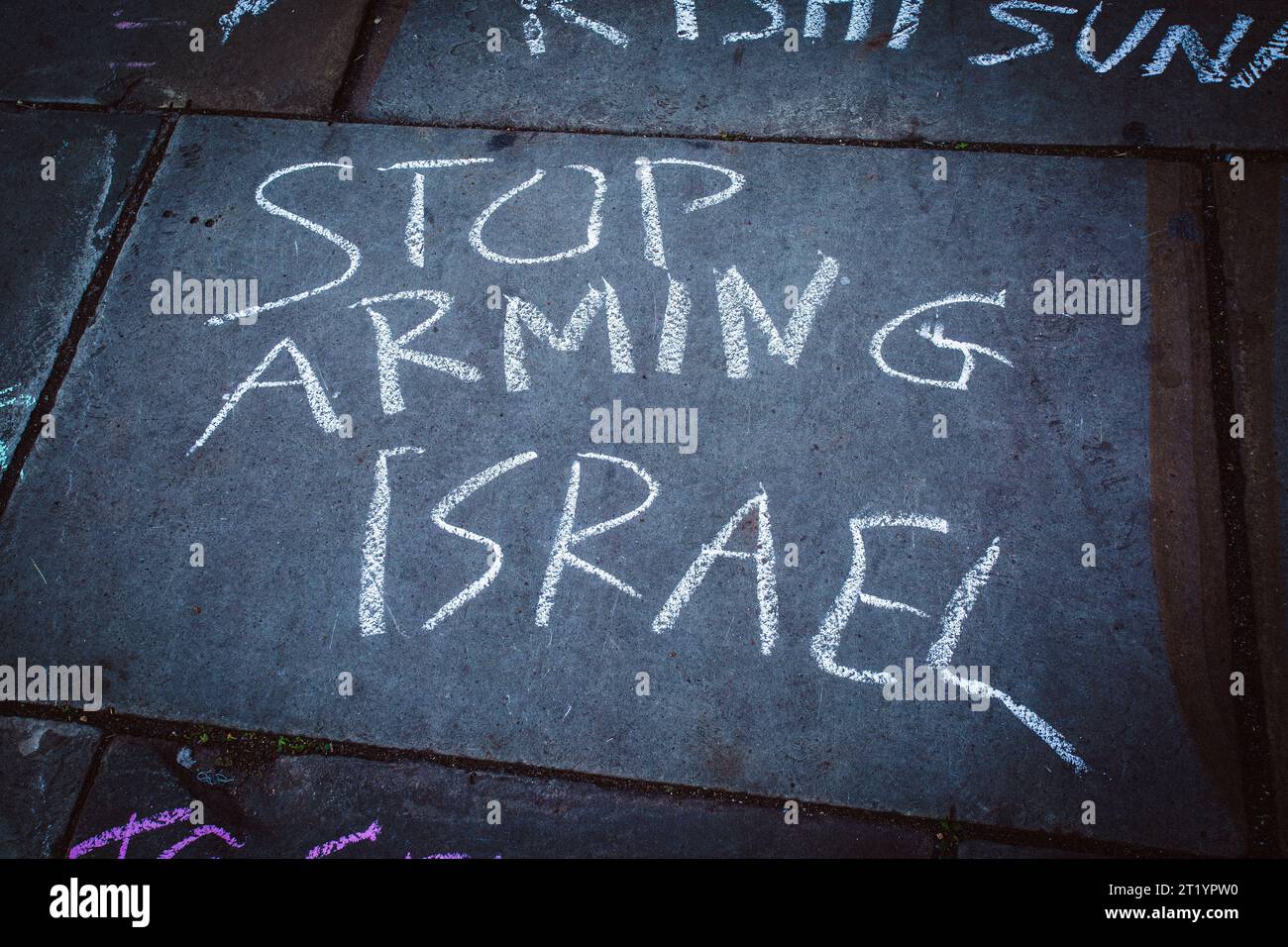 Protester painted  stop arming israel with chalk on the street during the Pro-Palestine protest in London . Stock Photo