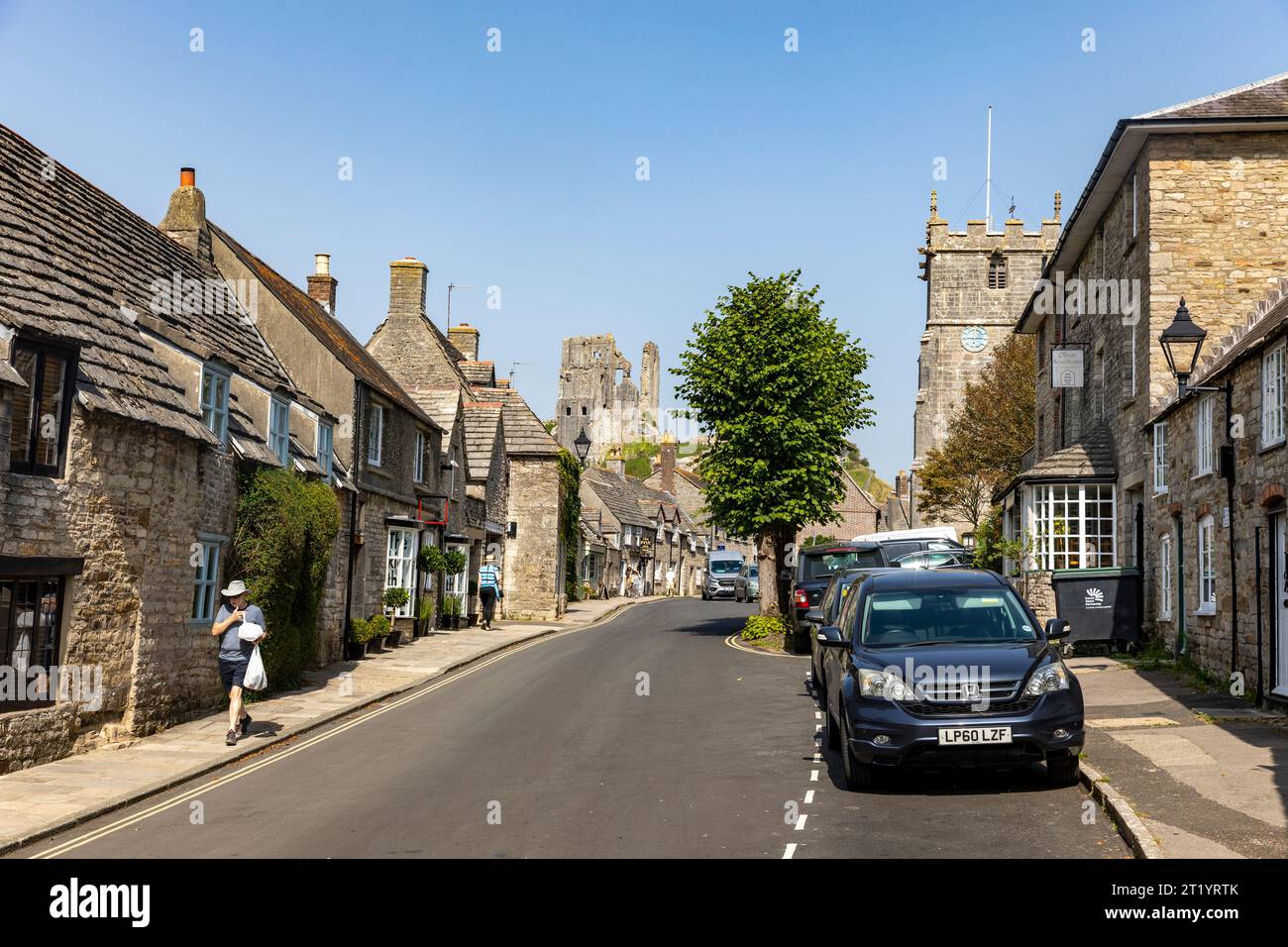 Corfe Castle village in Dorset blue sky sunny autumn day shops and houses on west street in the