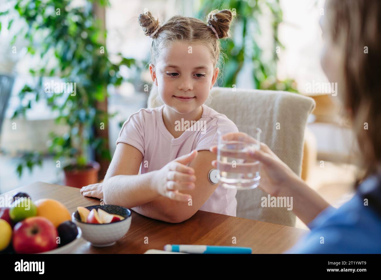 Diabetic girl drinking water to better manage her diabetes. Continuous