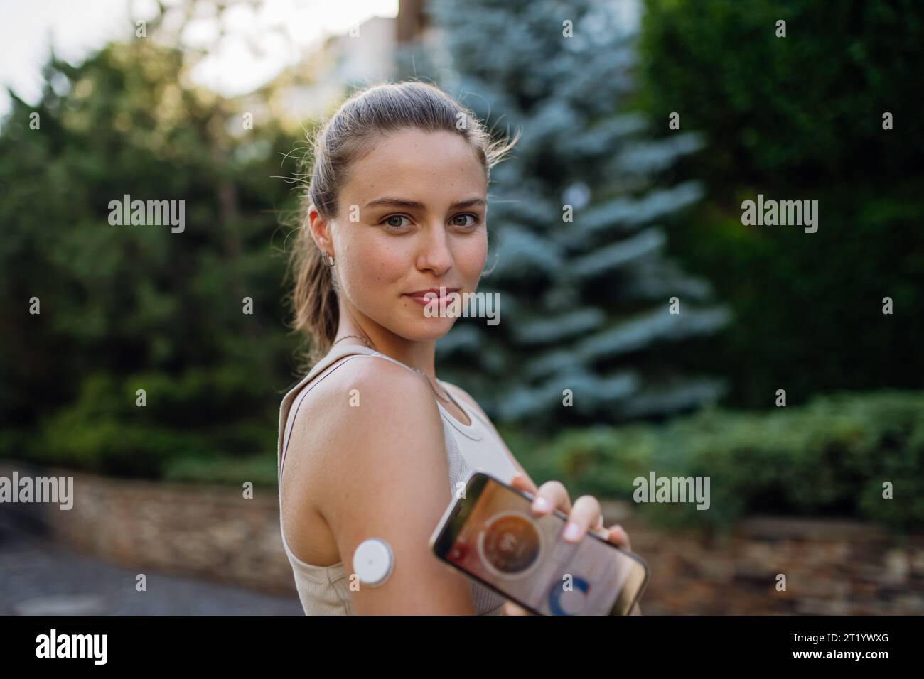 Woman with diabetes connecting her smartphone to continuous glucose