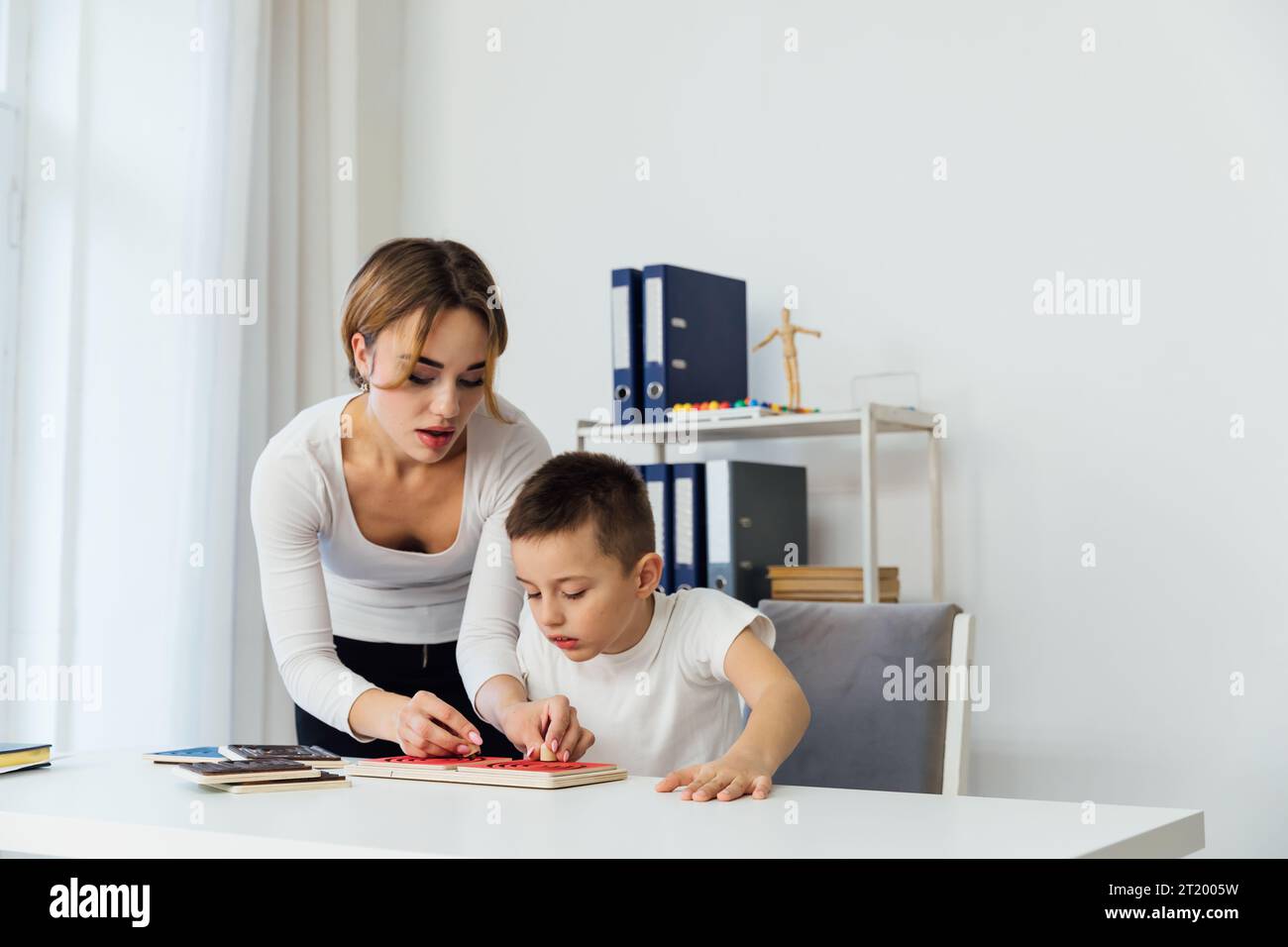 the work of a child psychologist with a child in the office of educational games Stock Photo