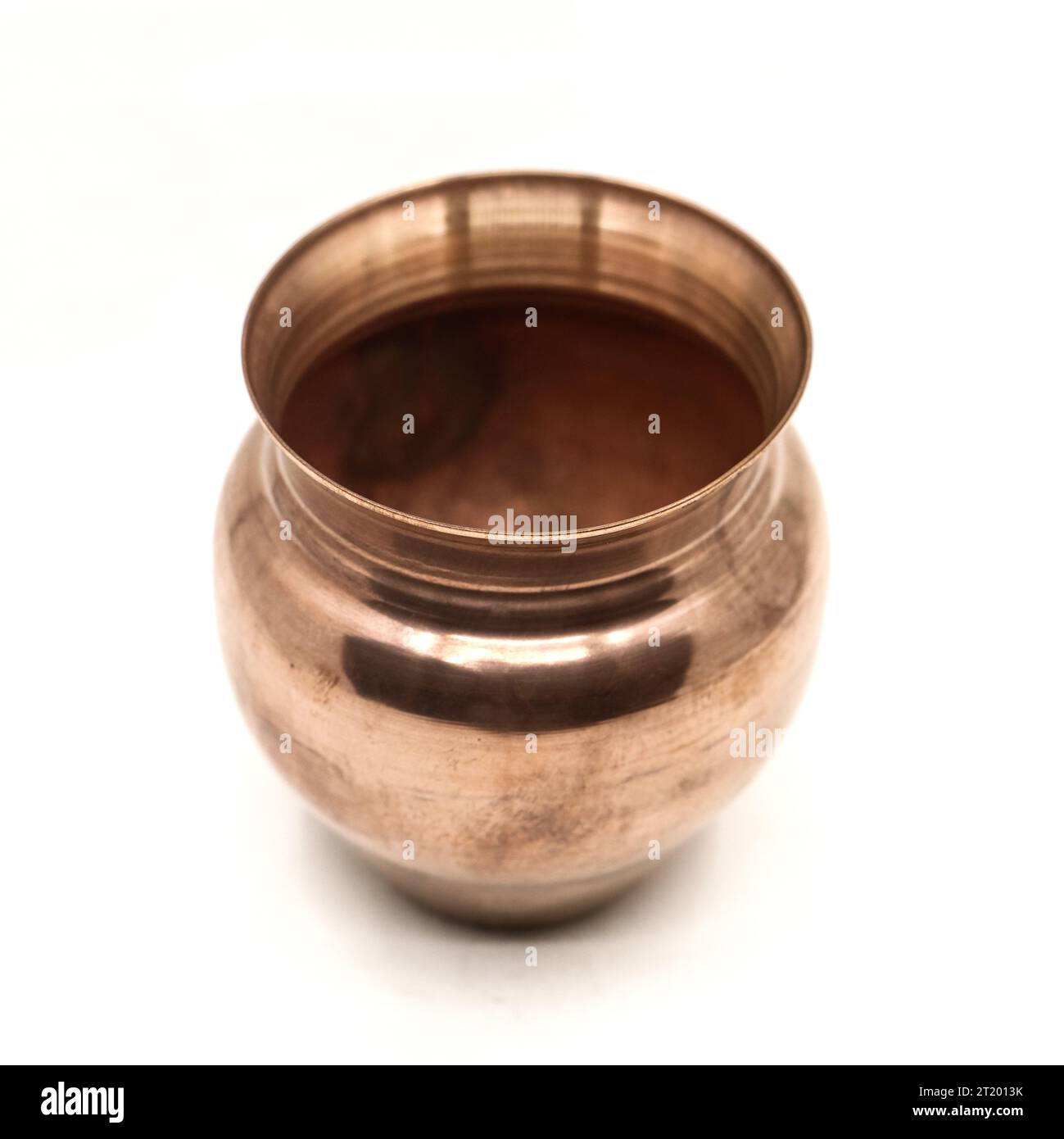 an old, vintage, empty copper pot vessel used for serving drinks and