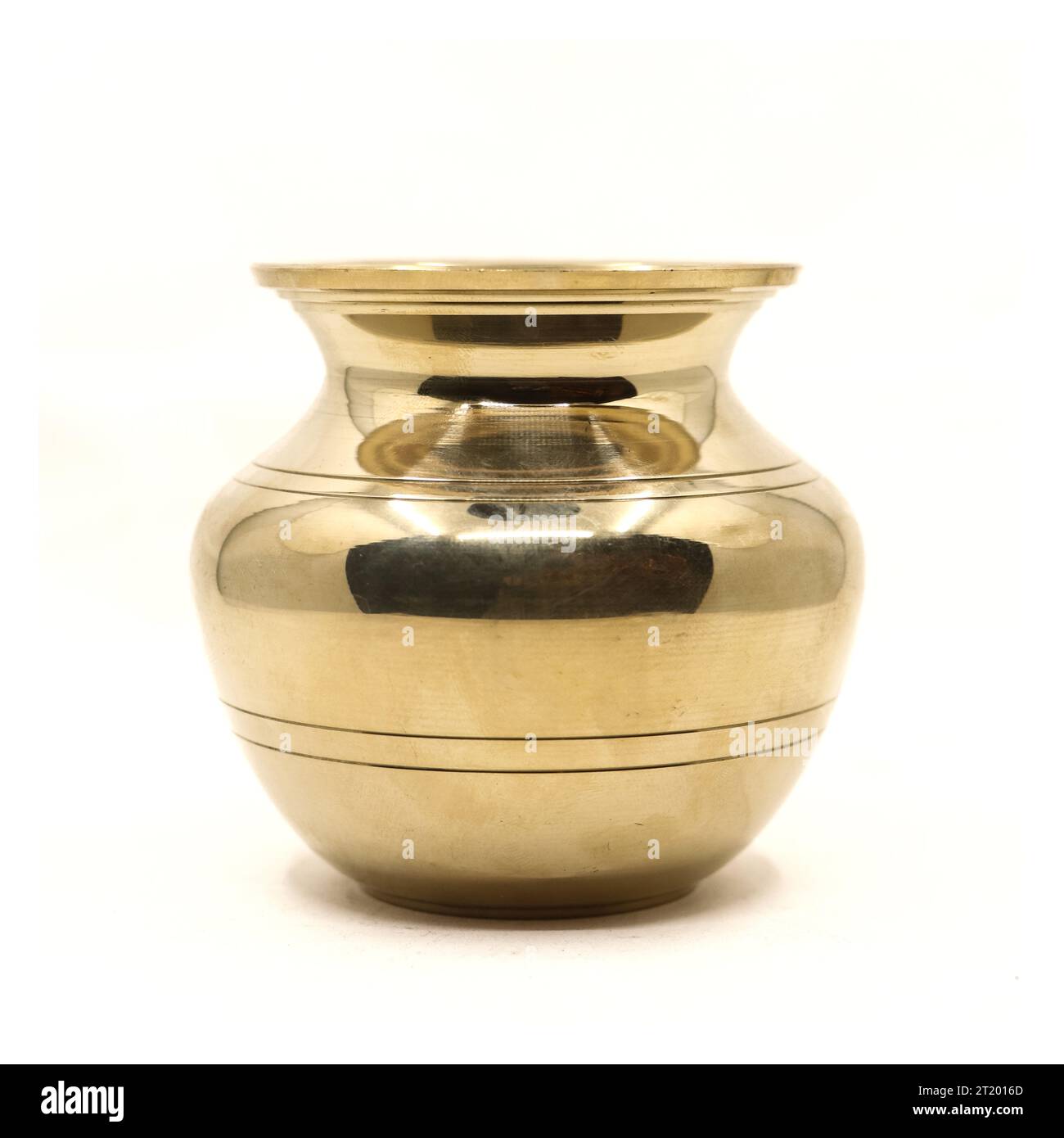 a clean golden indian brass vessel used as a water pot for traditional