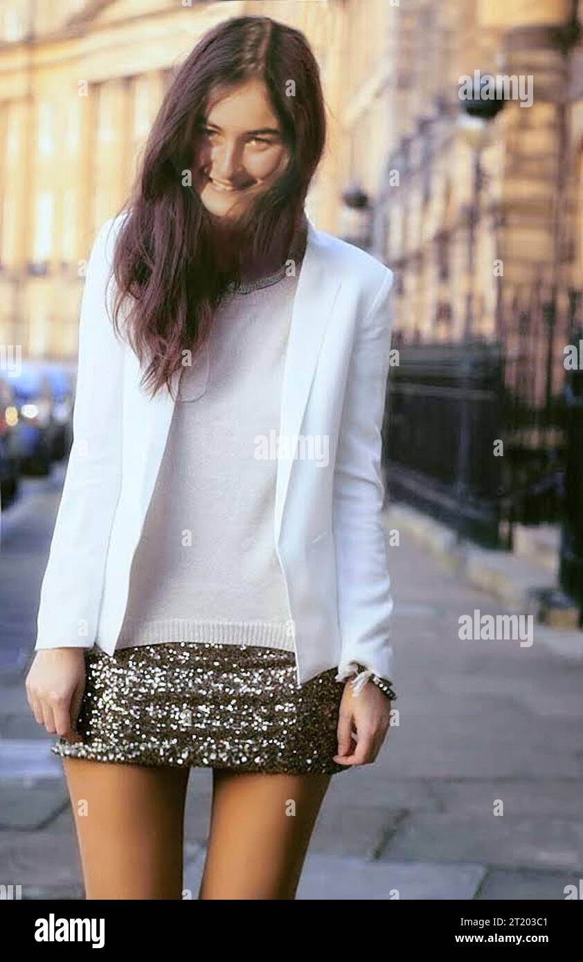 Charming and pretty brunette 18 year old young woman wearing a white