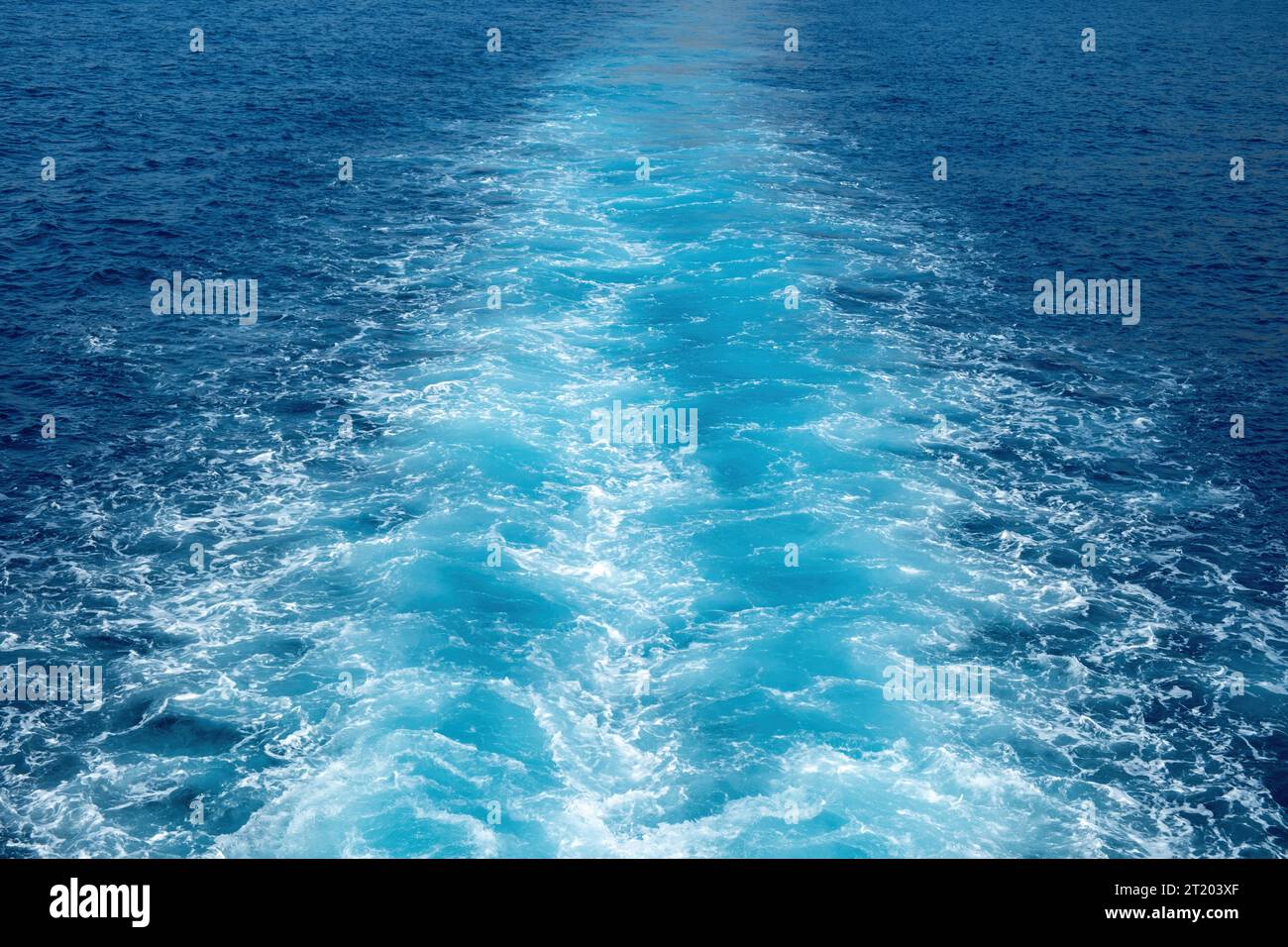 Boat white wake, prop wash foam on blue sea background texture. Ripple wavy deep water spray and splash behind ship. Space Stock Photo