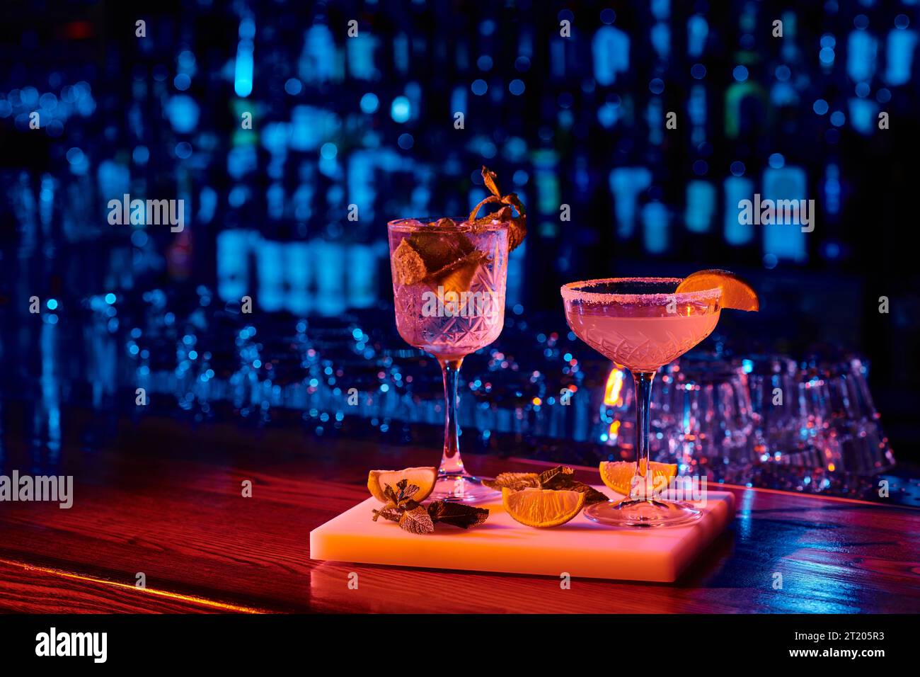 sophisticated glass of delicious cocktails with garnishments on bar counter, concept Stock Photo