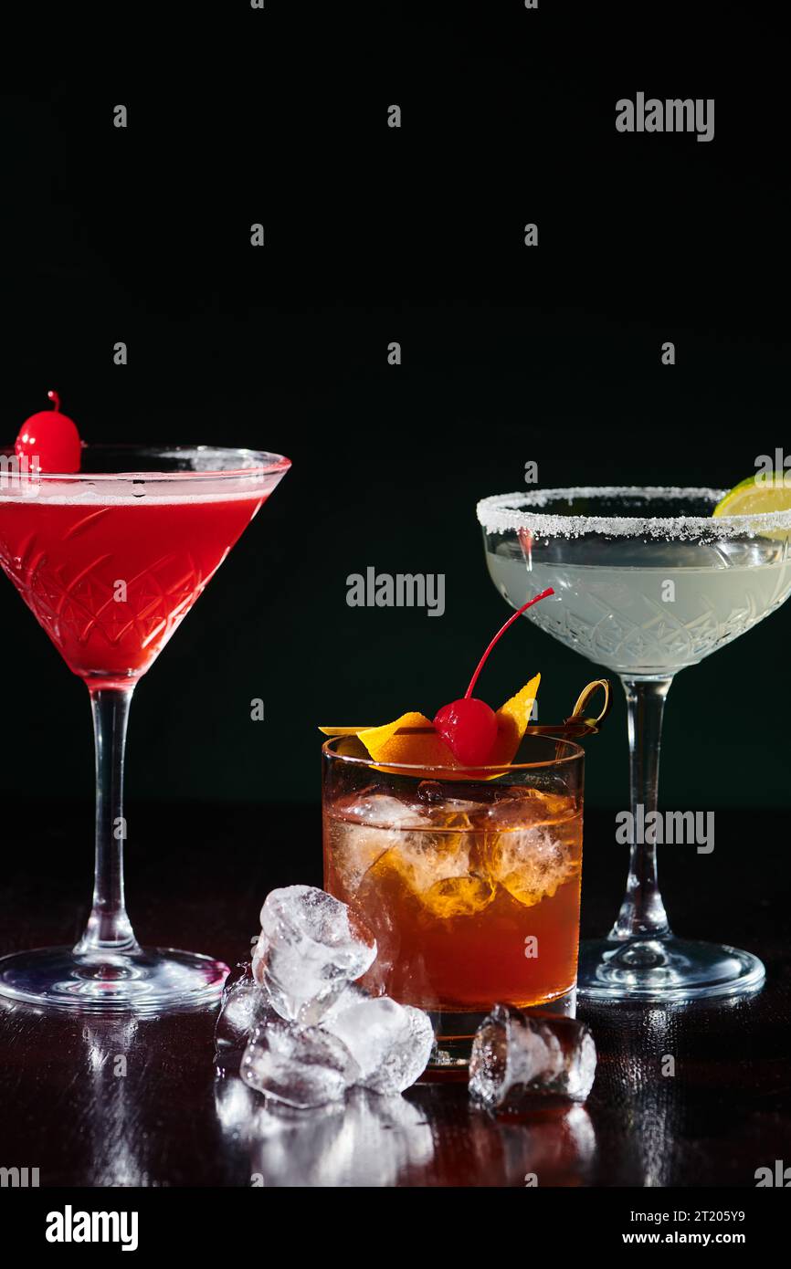 set of three esthetic freshening cocktails with berries and ice cubes on counter, concept Stock Photo