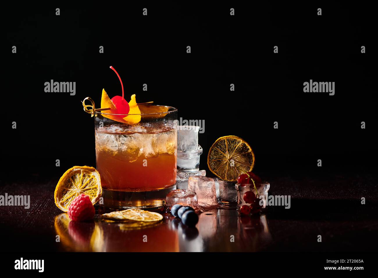 thirst quenching negroni garnished with cocktail cherry on black