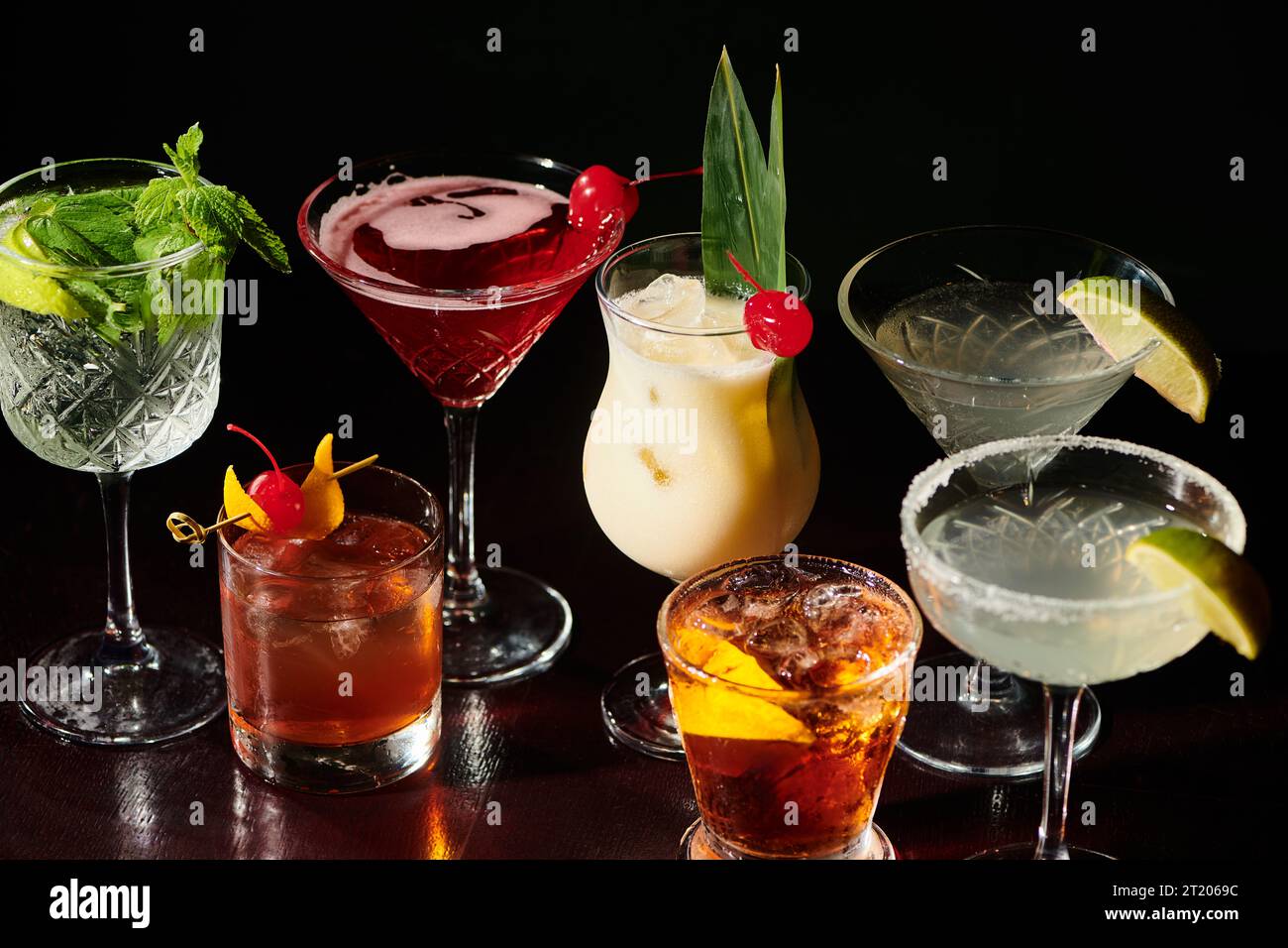 delicious refreshing set of esthetic cocktails with garnishments on black backdrop, concept Stock Photo
