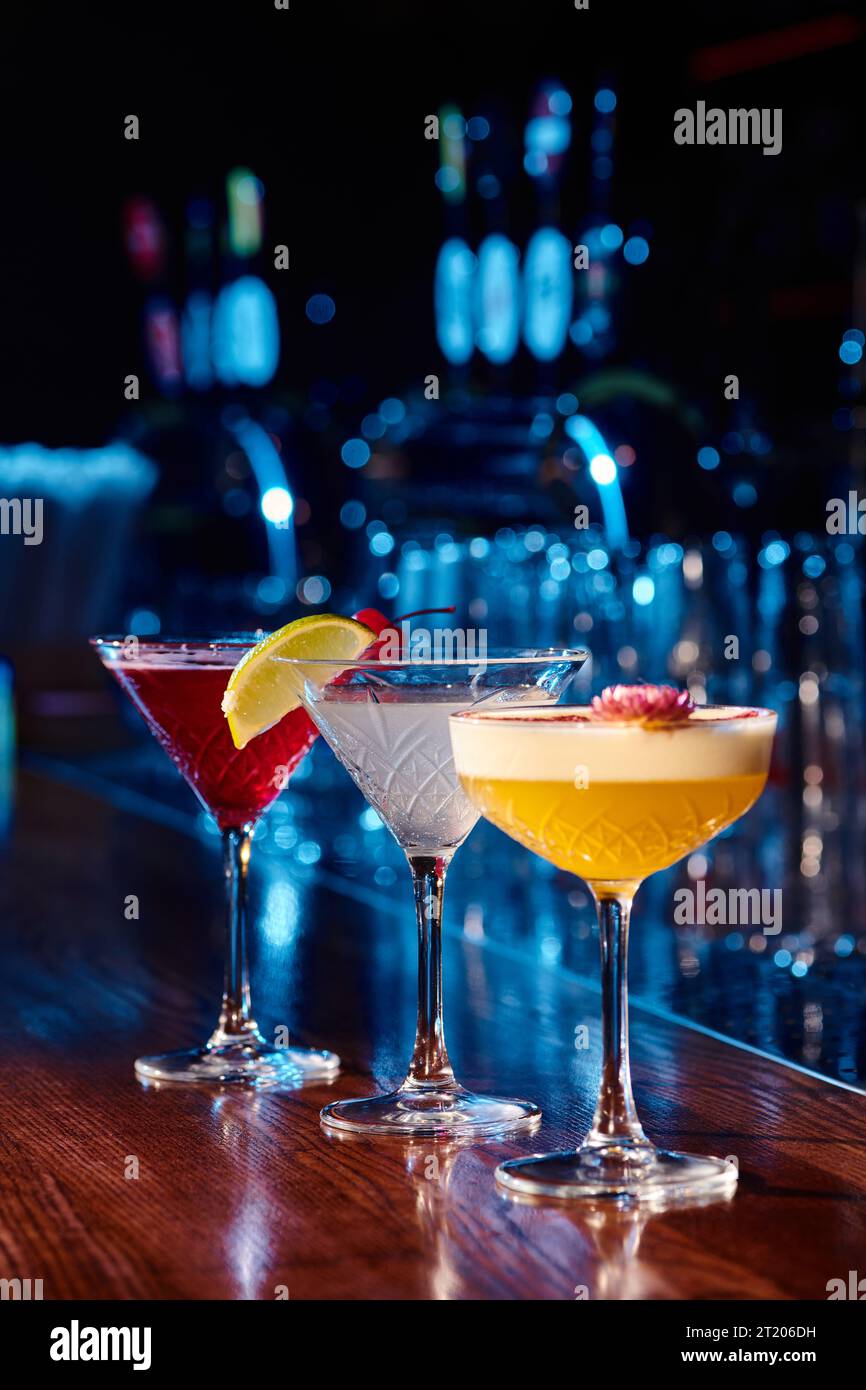 refreshing tropical daiquiri with elegant martini and cosmopolitan on bar counter, concept Stock Photo