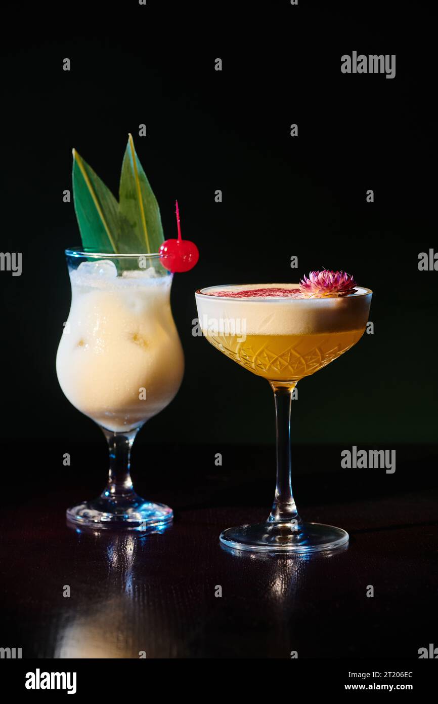 tropical exotic pina colada and daiquiri with fresh garnishing on black backdrop, concept Stock