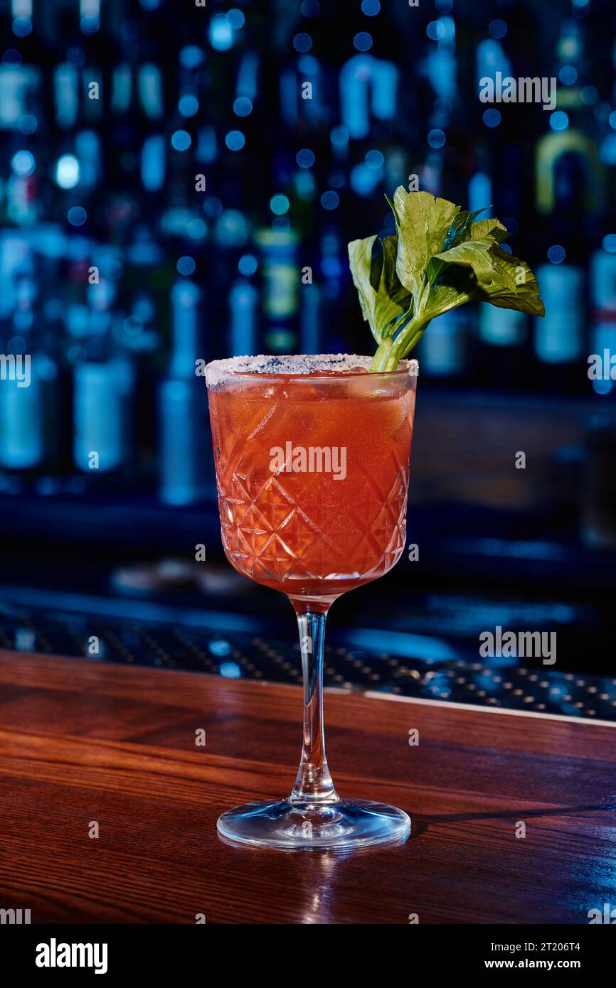 sophisticated bloody mary cocktail decorated with celery stalk on bar