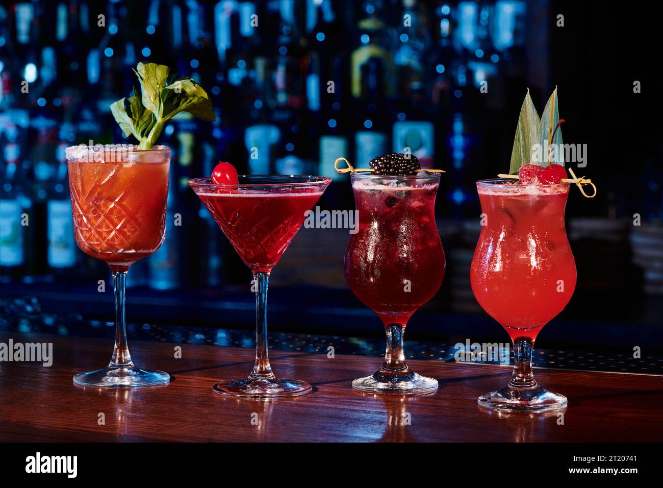 freshening set of four cocktails with garnishments on counter with bar backdrop, concept Stock Photo
