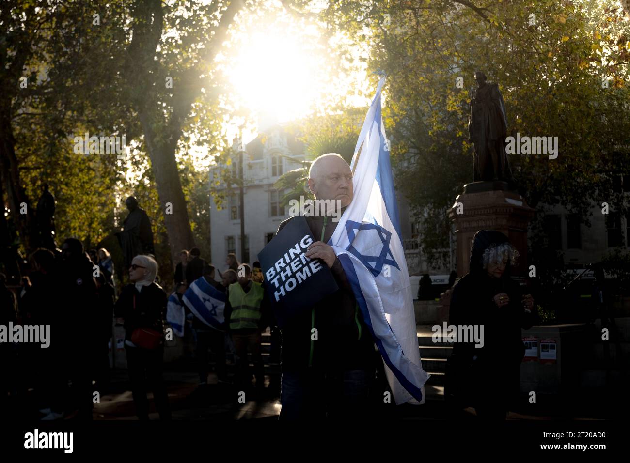 London, UK. 15th October, 2023. Hundreds of British Jews and members of the Israeli community in London hold a vigil in Parliament Square following Hamas’s October 7 assault in Israel and the ongoing conflict in Gaza. Many carried Israeli flags, some held signs saying “bring them home” on one side with pictures of the hostages on the other. The grassroots-organised vigil featured speeches as well as prayers, singing in Hebrew and a testimonials  from the Nova music festival where hundreds were killed. Supporters are urging Hamas to free hostages. Credit: Guy Corbishley/Alamy Live News Stock Photo