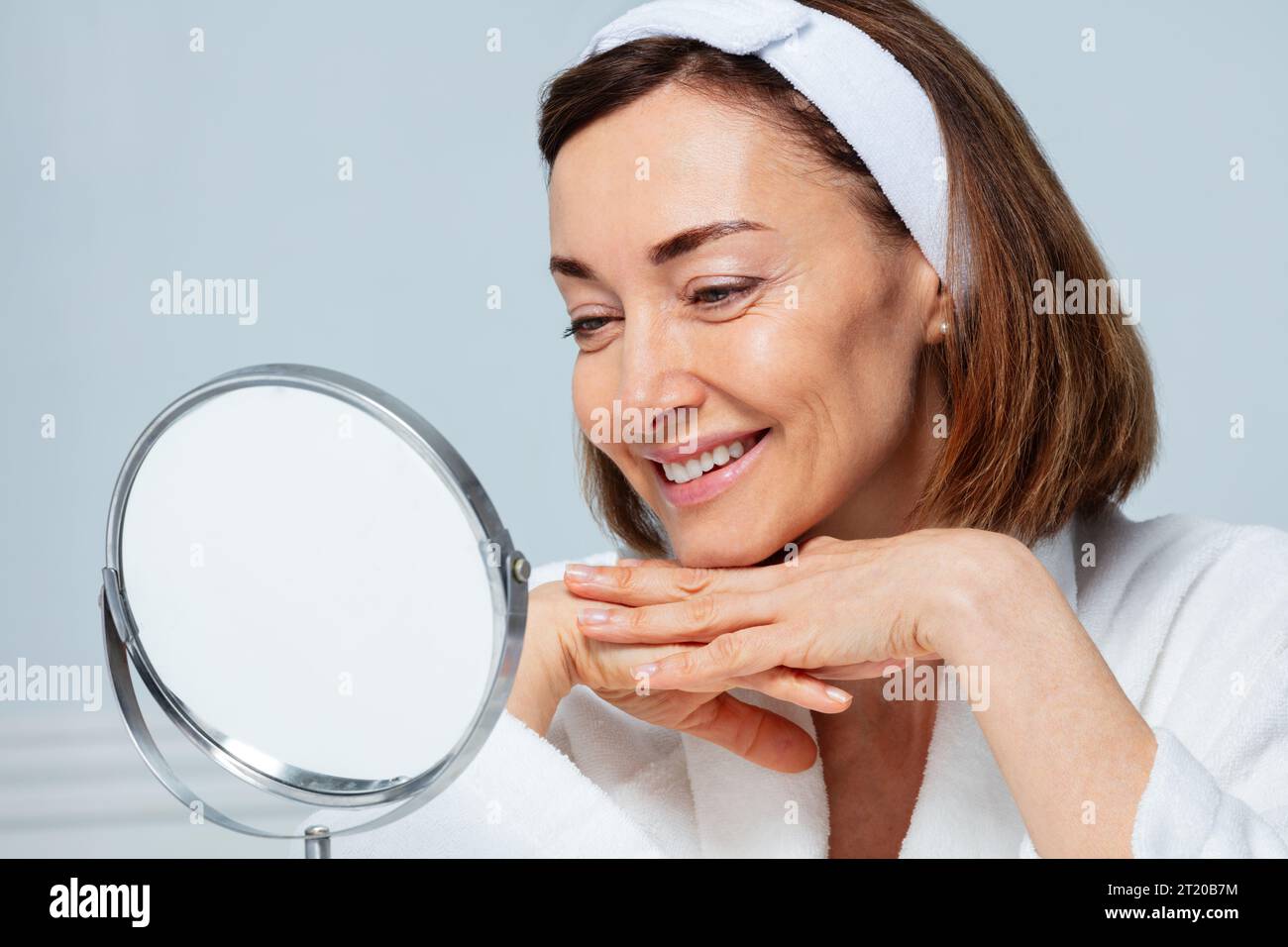 Mature woman mirror smiling hi-res stock photography and images - Alamy