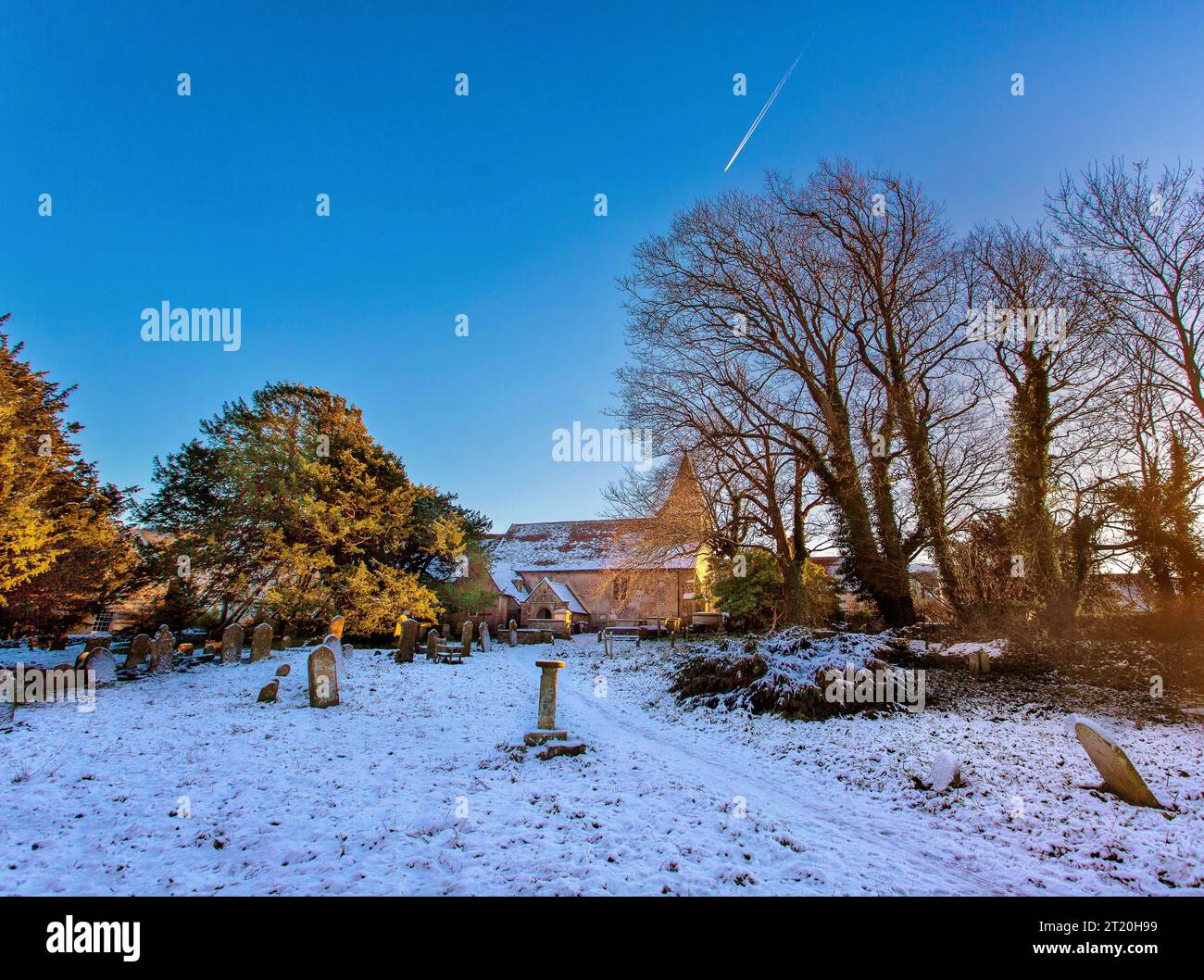 The Church of St Mary and St Peter, WIlmington, East Sussex, on a snowy winter evening Stock Photo