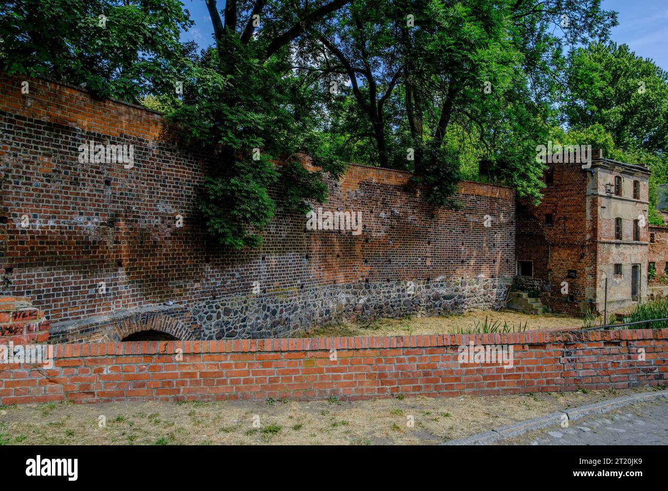 Abandoned, dilapidated building integrated into the old historic town wall of Namyslow (Namslau), Opole Voivodeship, Poland. Stock Photo