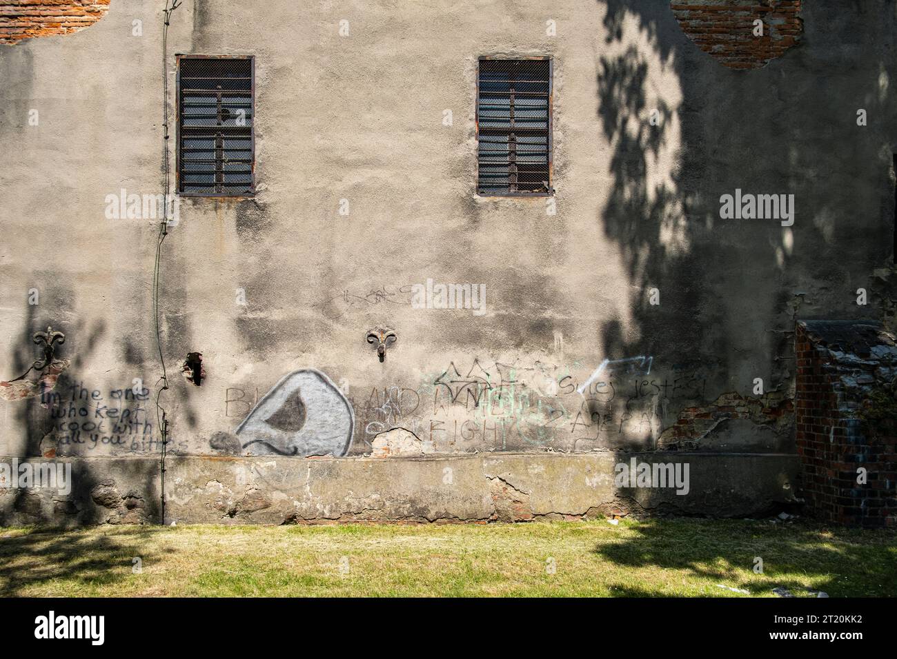 Wall graffiti on an dilapidated building integrated into the old historic town wall of Namyslow (Namslau), Opole Voivodeship, Poland. Stock Photo