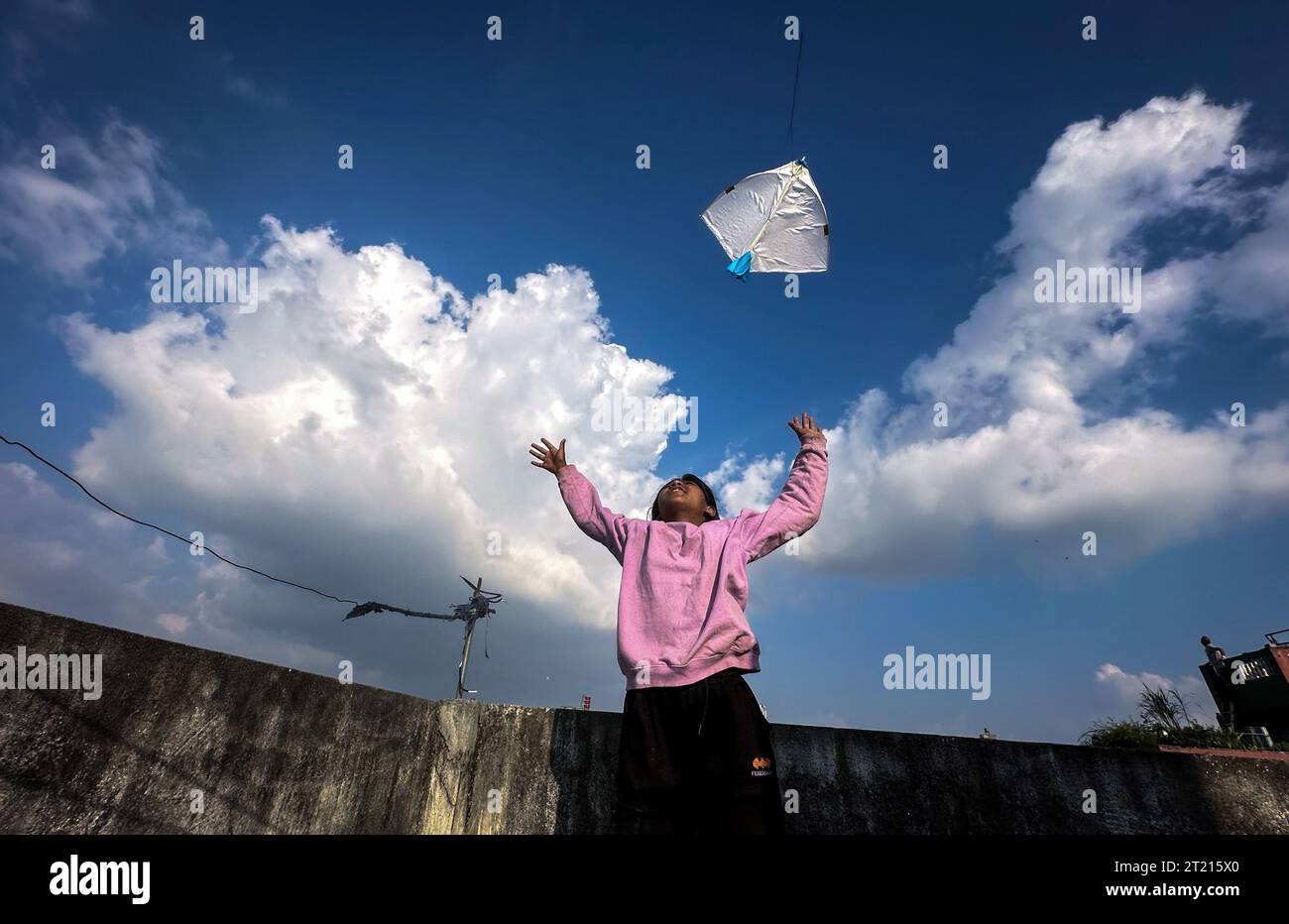 Kathmandu, Bagmati, Nepal. 16th Oct, 2023. A small girl jumps to fly a