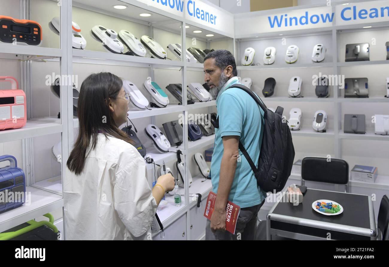 (231016) -- GUANGZHOU, Oct. 16, 2023 (Xinhua) -- A buyer from Pakistan visits a booth for window cleaning machines at the 134th session of the China Import and Export Fair in Guangzhou, south China's Guangdong Province, Oct. 15, 2023. The 134th session of the China Import and Export Fair, also known as the Canton Fair, has attracted exhibitors and buyers from across the globe. About 60 percent of the exhibitors attending the import exhibition are Belt and Road Initiative (BRI) partner countries, and the number of buyers from BRI partner countries has witnessed an increase of 11.2 percent compa Stock Photo