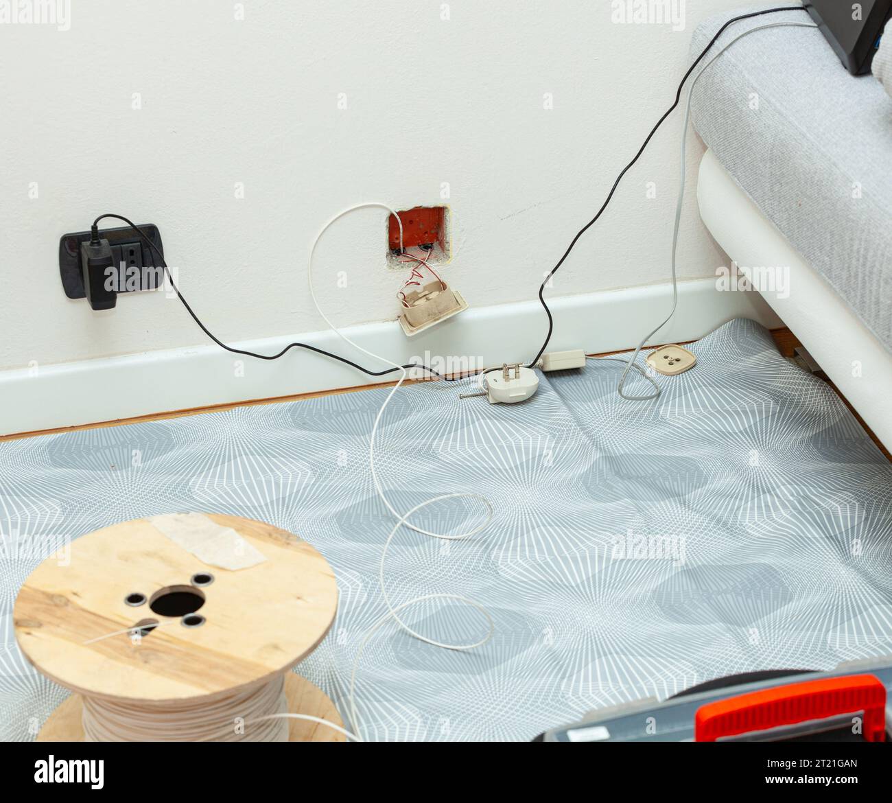Fiber optic cable passage in the apartment with replacement of the traditional telephone socket. Stock Photo